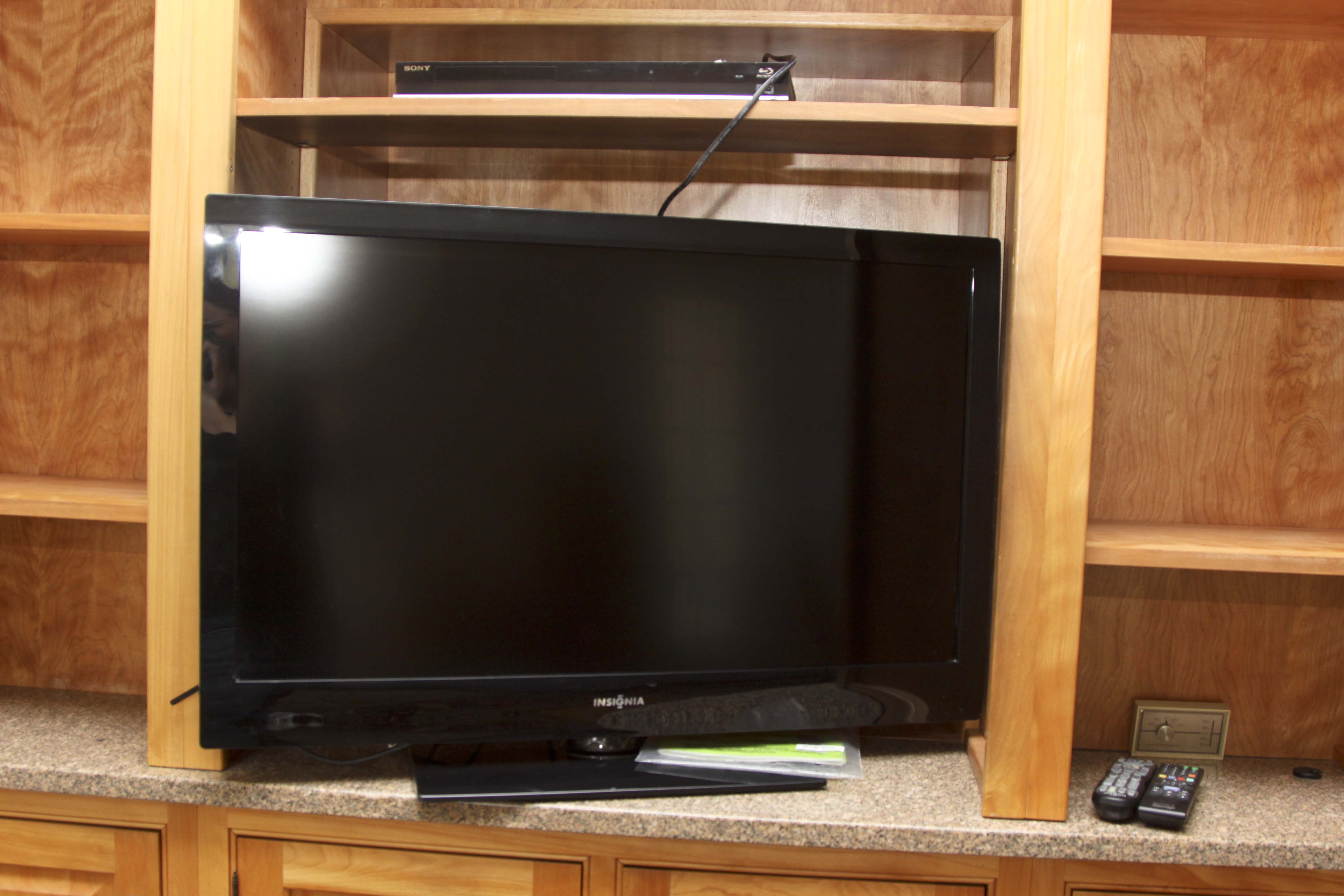 Insignia Flat Screen Television with Sony Blue Ray DVD Player and Collection of DVDs
