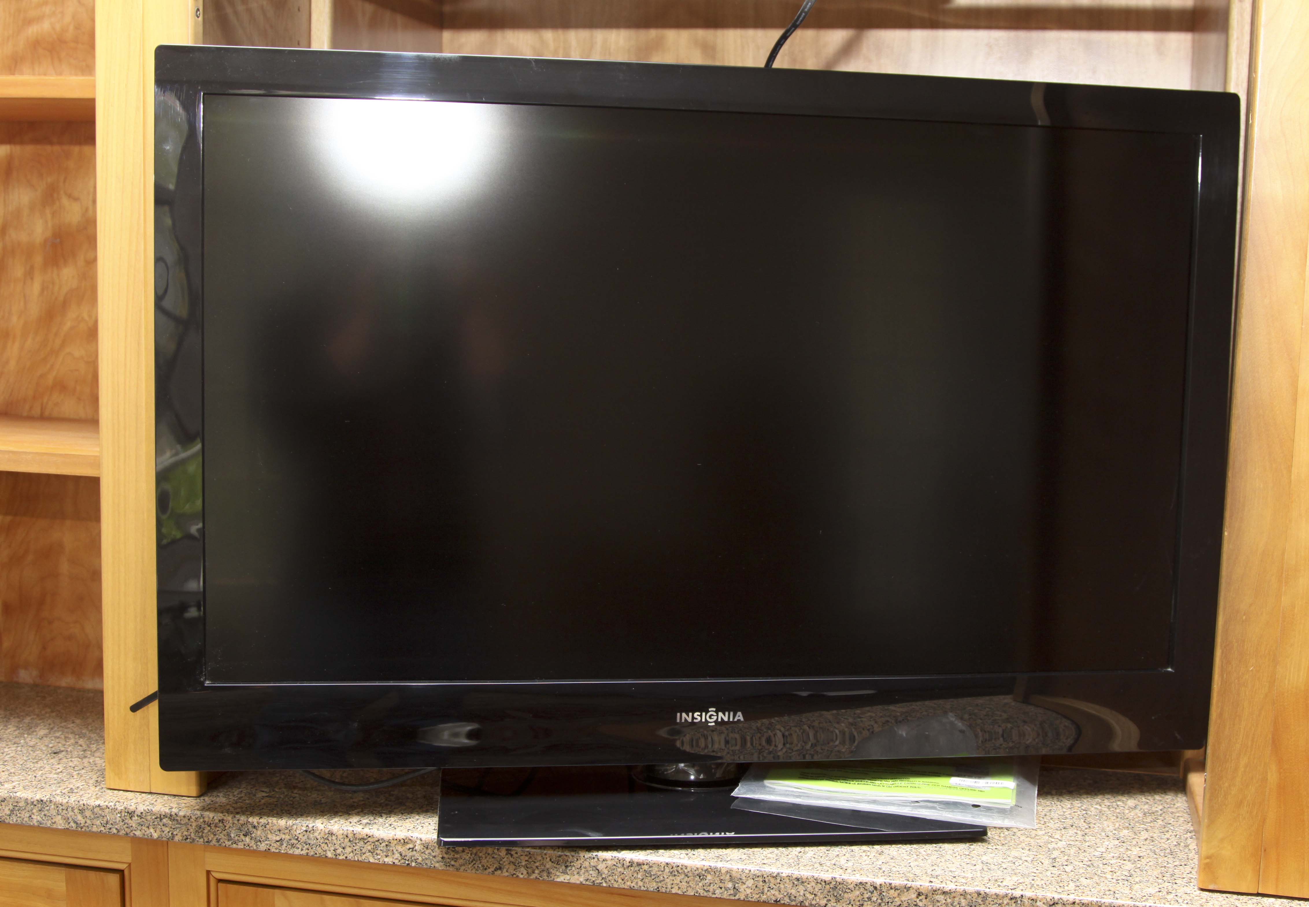 Insignia Flat Screen Television with Sony Blue Ray DVD Player and Collection of DVDs
