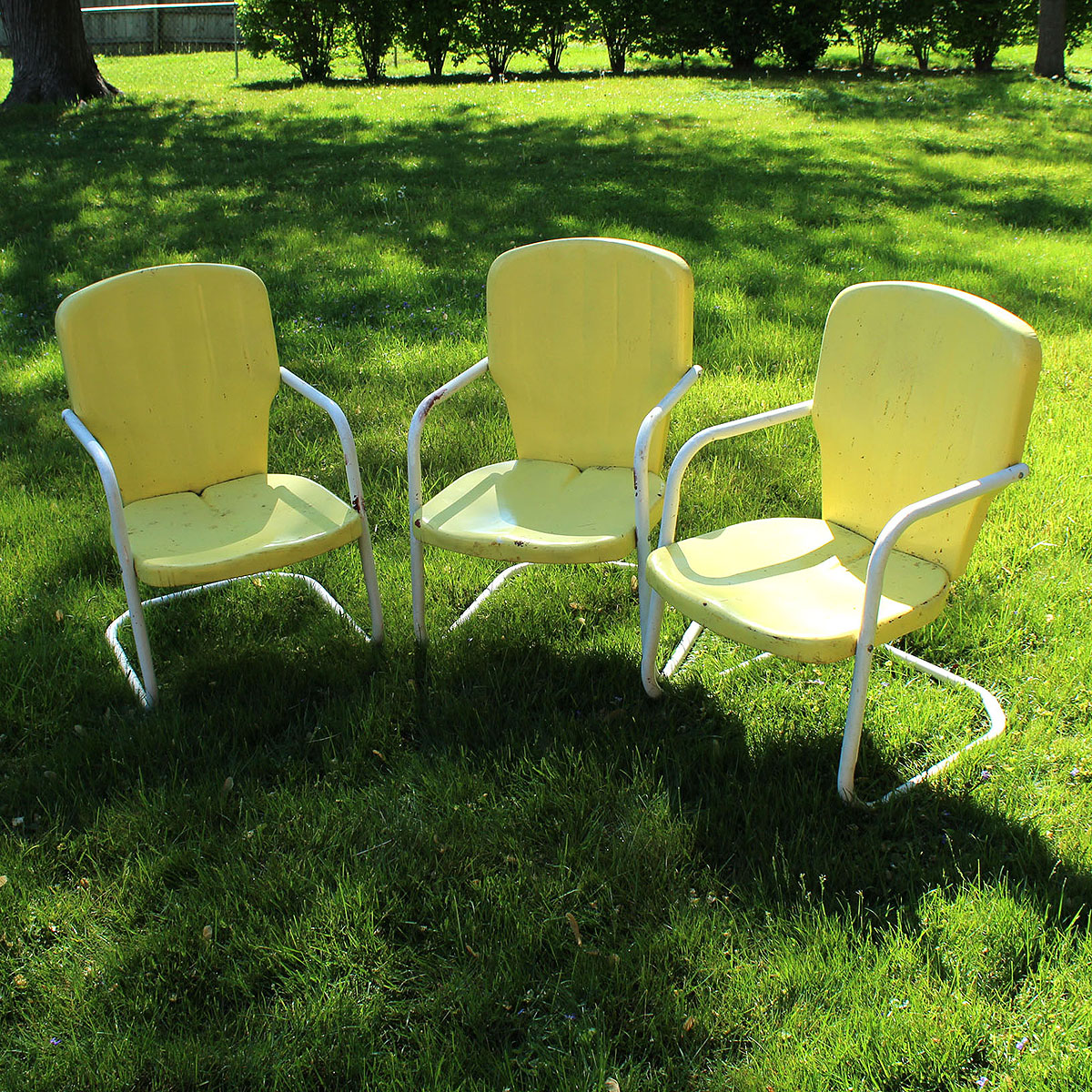 Three Vintage Yellow Metal Patio Chairs