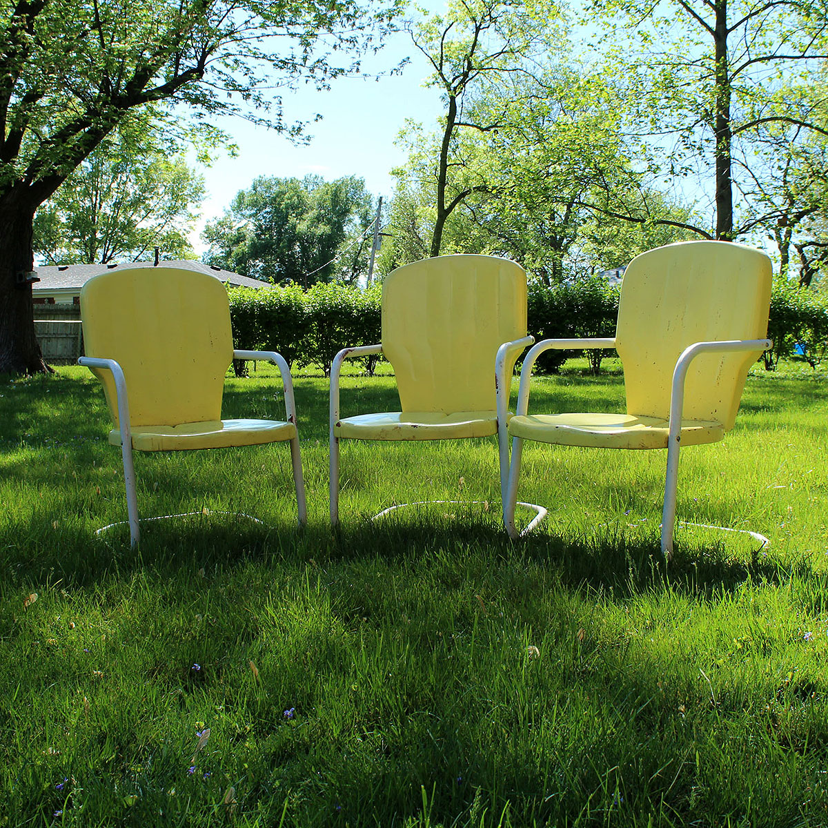 Three Vintage Yellow Metal Patio Chairs