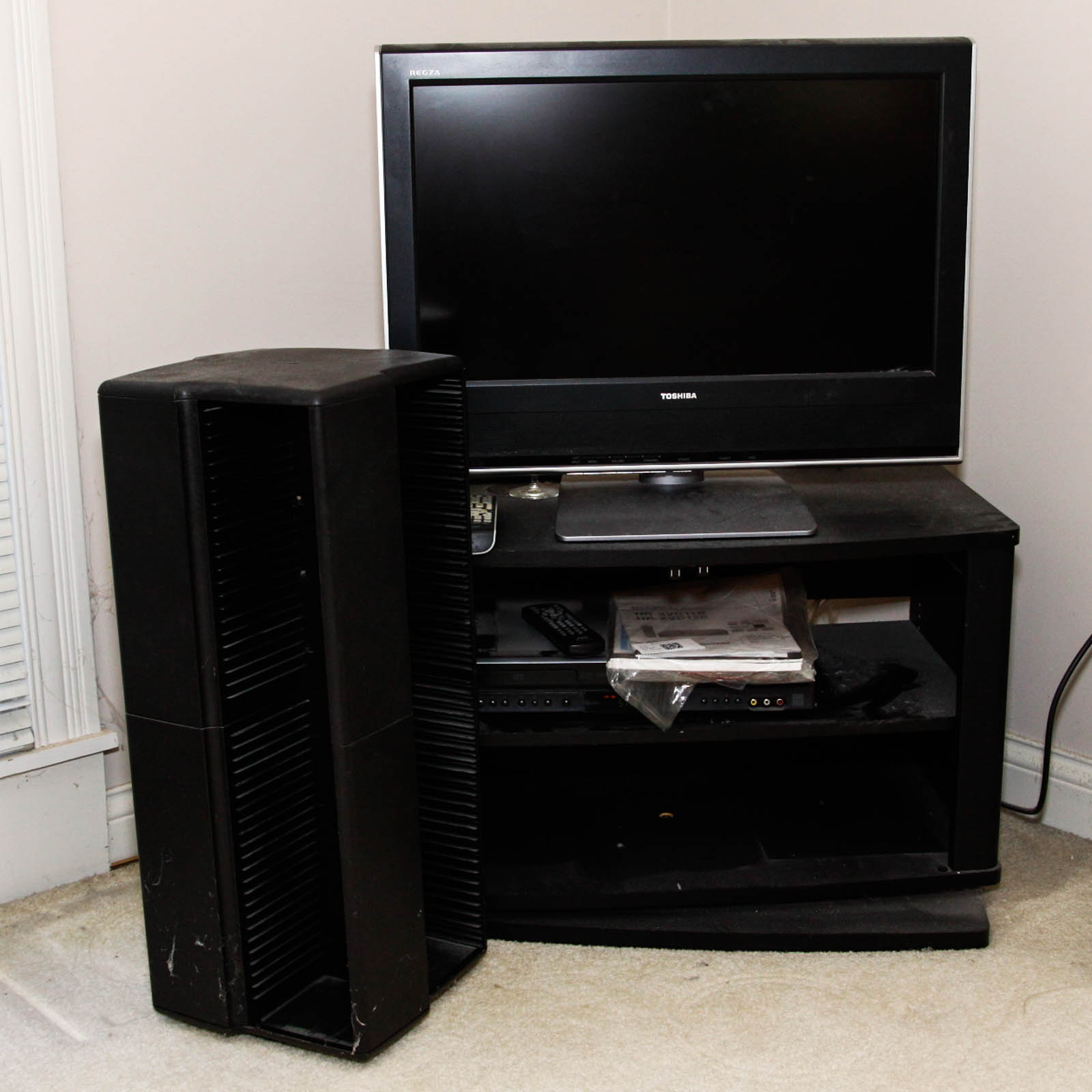 Toshiba Flat Screen Television Mounted on Black Two Shelf Cabinet