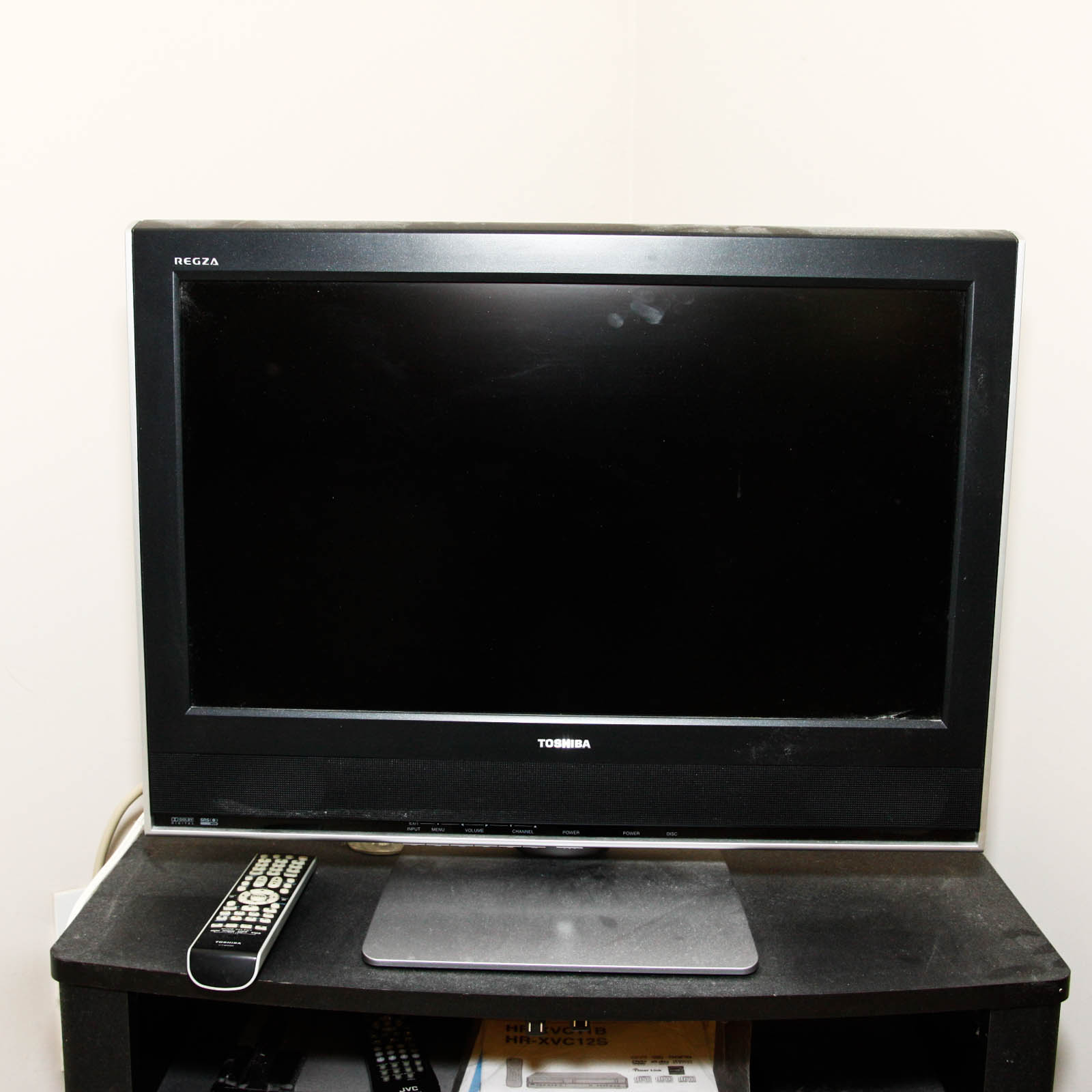 Toshiba Flat Screen Television Mounted on Black Two Shelf Cabinet