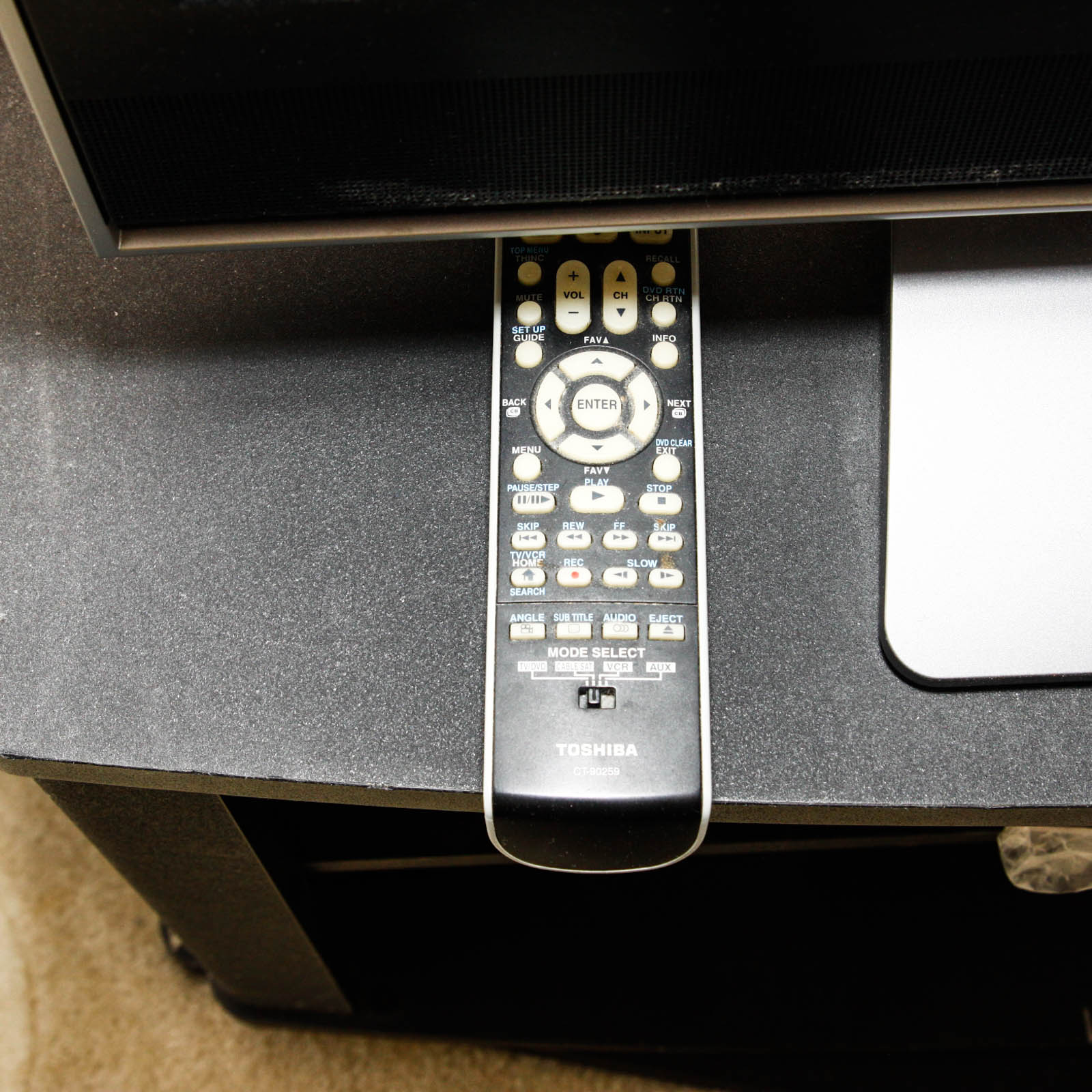 Toshiba Flat Screen Television Mounted on Black Two Shelf Cabinet