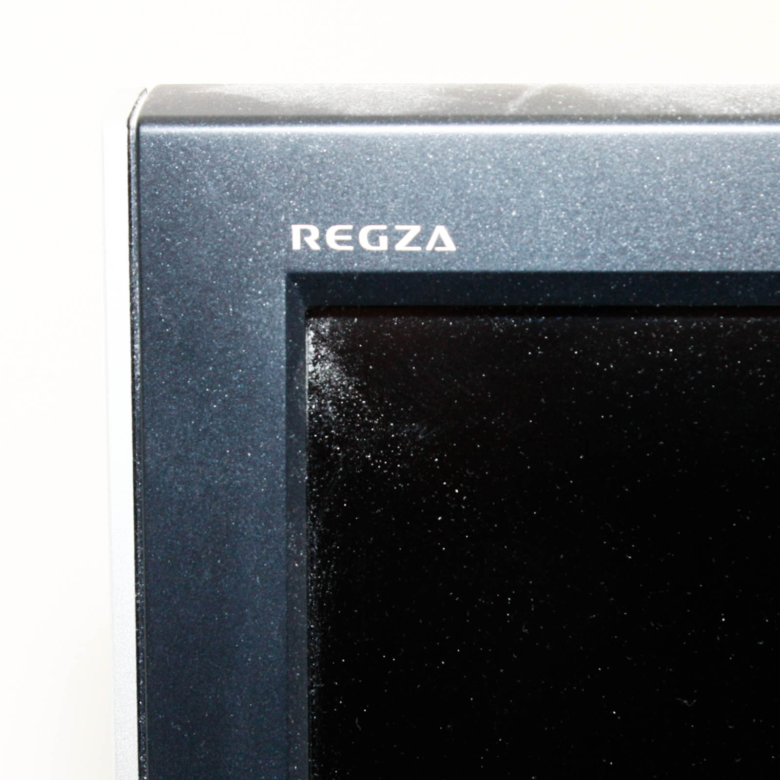 Toshiba Flat Screen Television Mounted on Black Two Shelf Cabinet