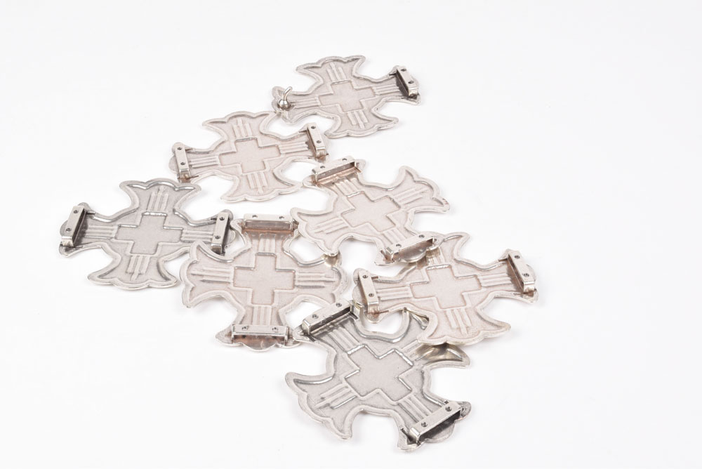 A Group of Six Silvertone Crosses with a Matching Cross Buckle for Adorning a Belt