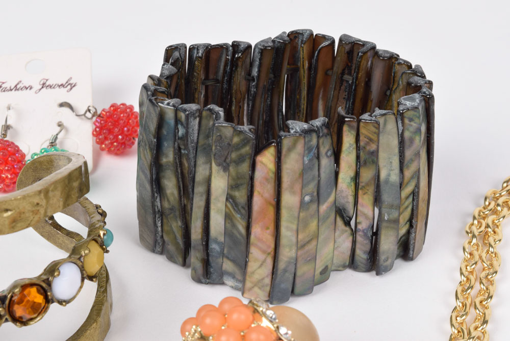 Collection of Costume Jewelry Including a Carved Shell Stretch Bracelet