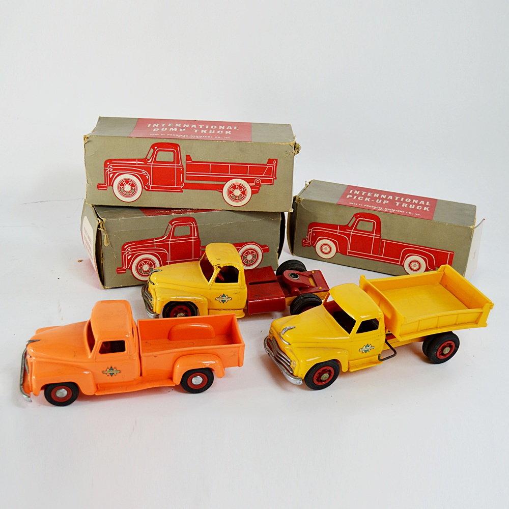 Three 1950s International Plastic Toy Trucks with Boxes