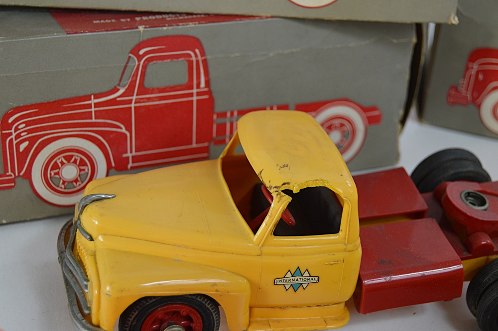 Three 1950s International Plastic Toy Trucks with Boxes