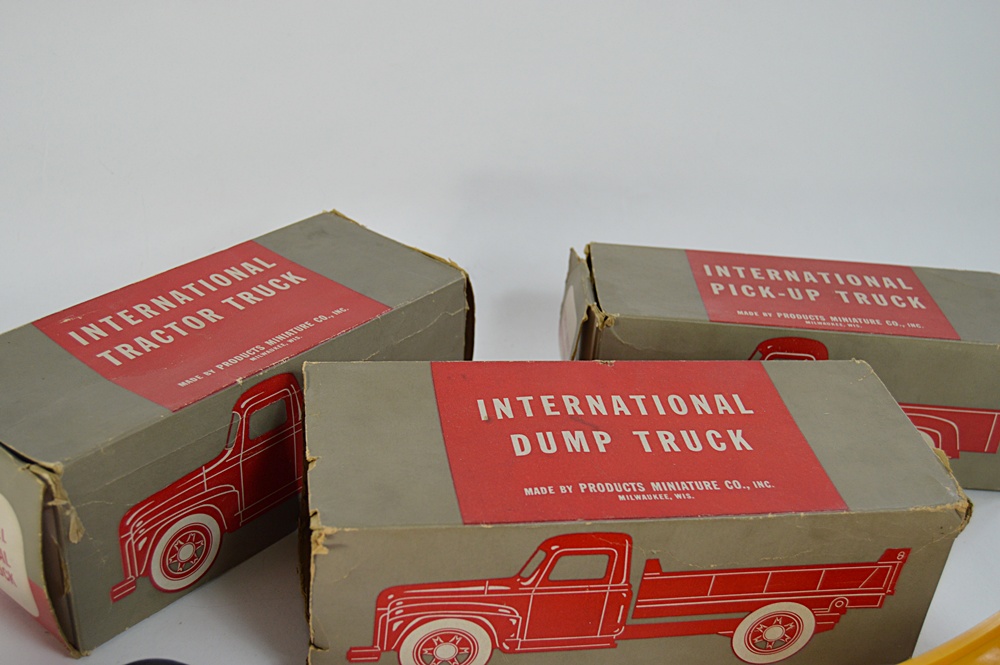 Three 1950s International Plastic Toy Trucks with Boxes