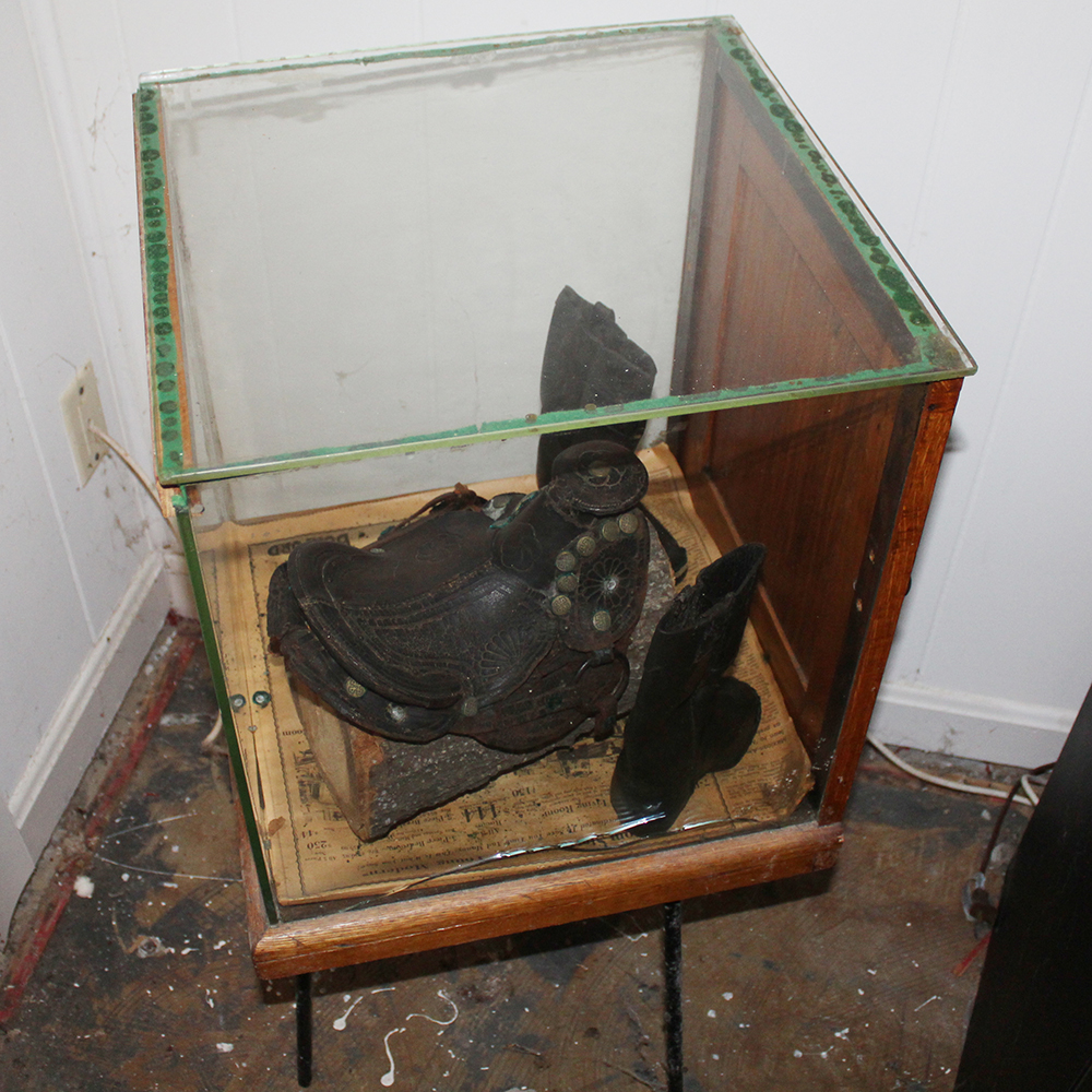 Antique Display Case Containing Children's Boots and Saddle