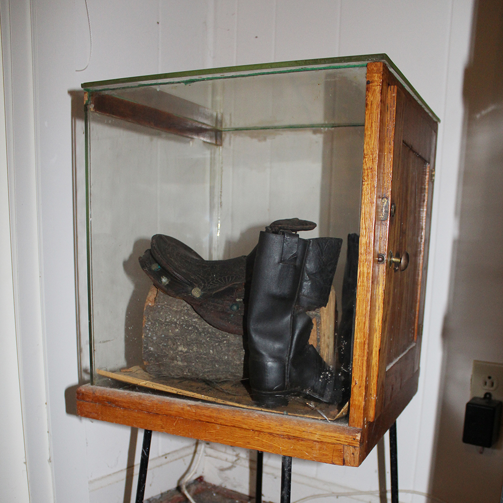 Antique Display Case Containing Children's Boots and Saddle