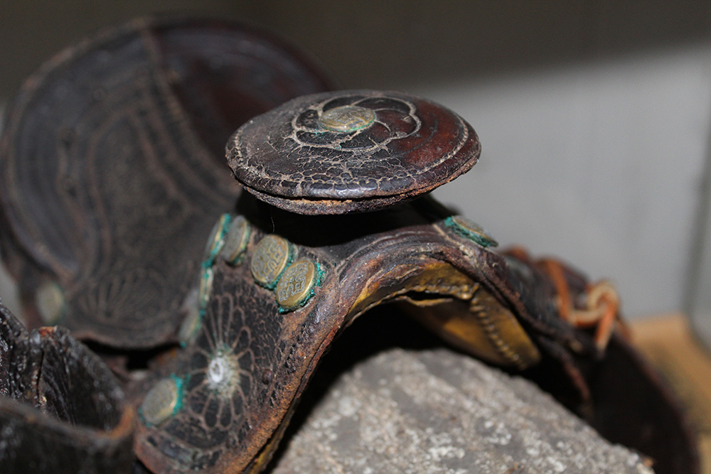 Antique Display Case Containing Children's Boots and Saddle