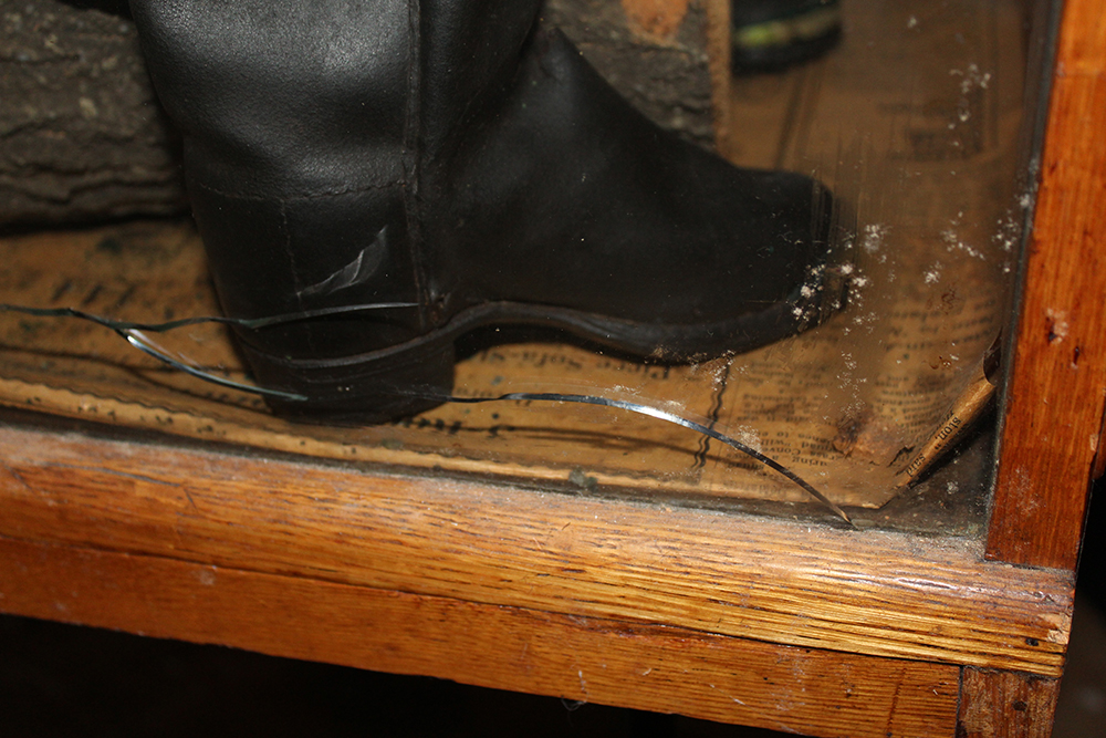 Antique Display Case Containing Children's Boots and Saddle