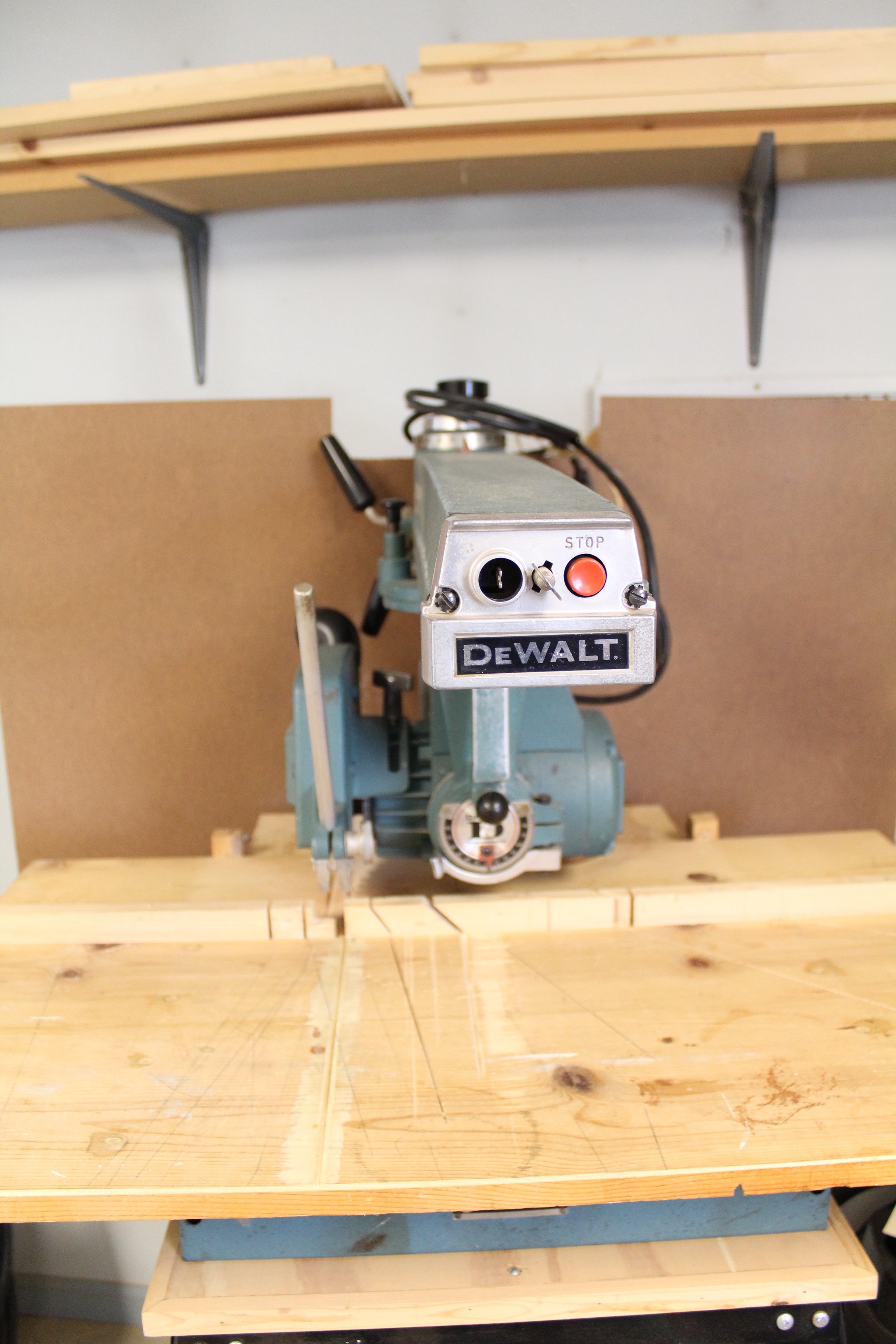DeWalt Power Shop Radial Arm Saw on Stand and Wall of Blades