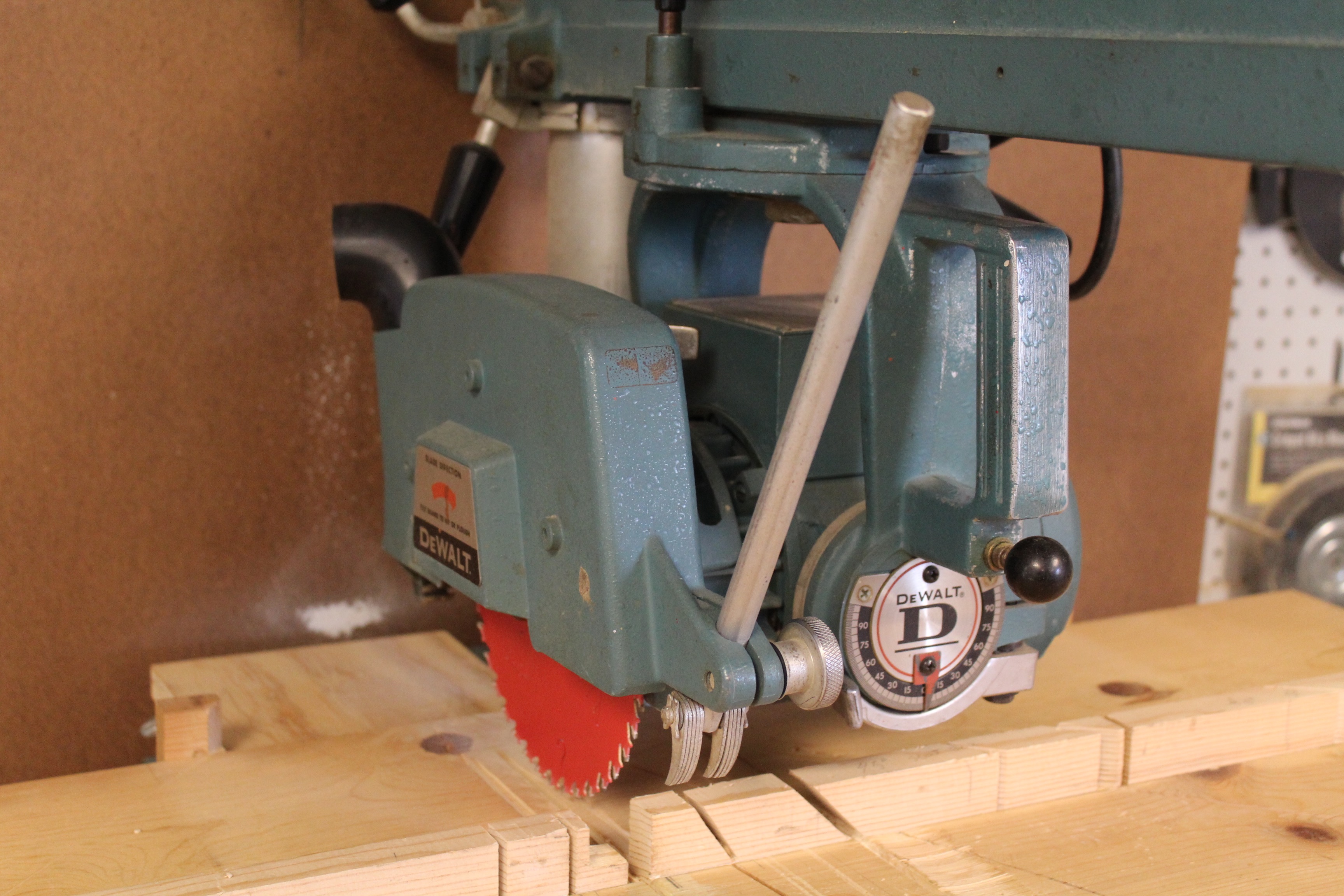 DeWalt Power Shop Radial Arm Saw on Stand and Wall of Blades