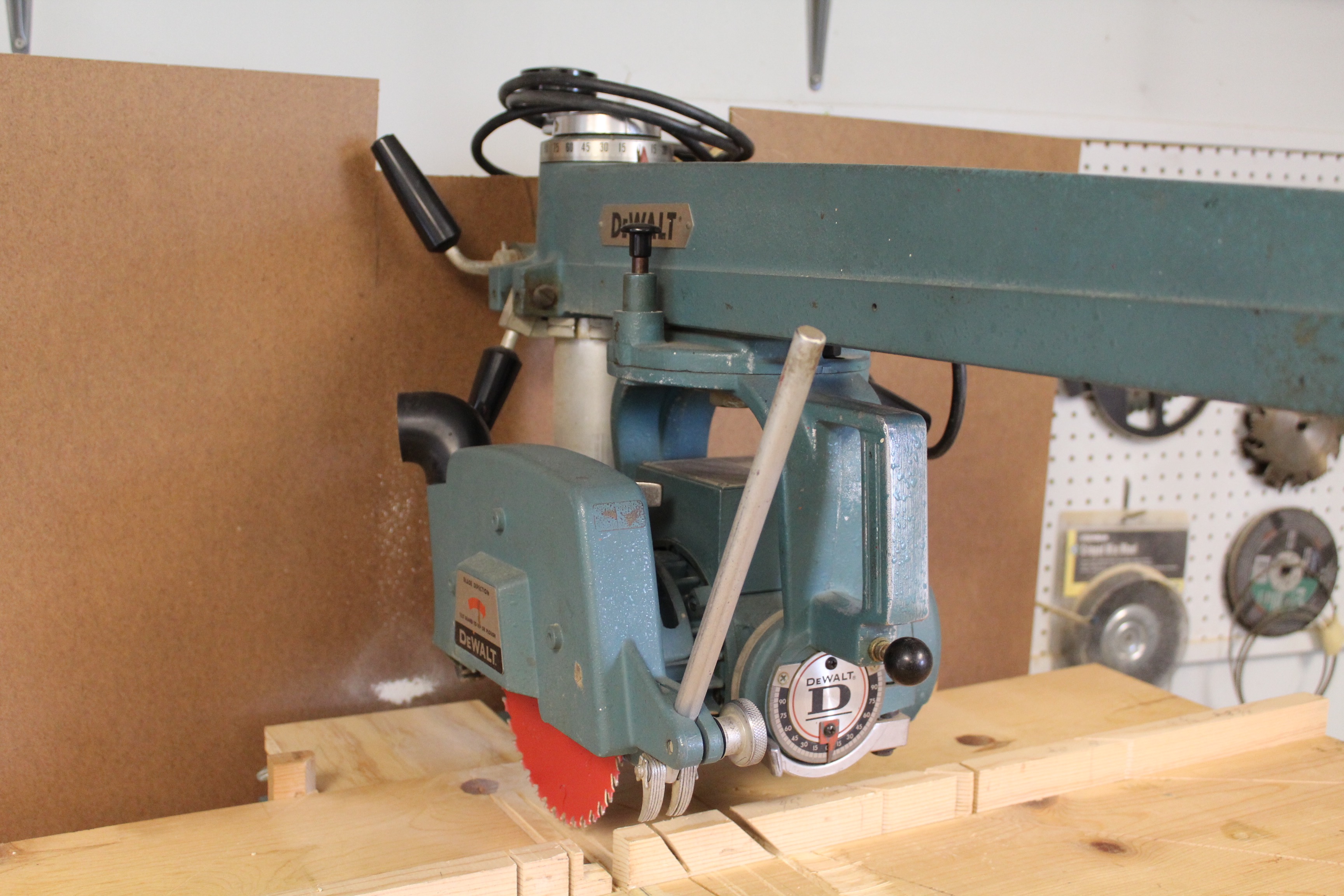DeWalt Power Shop Radial Arm Saw on Stand and Wall of Blades