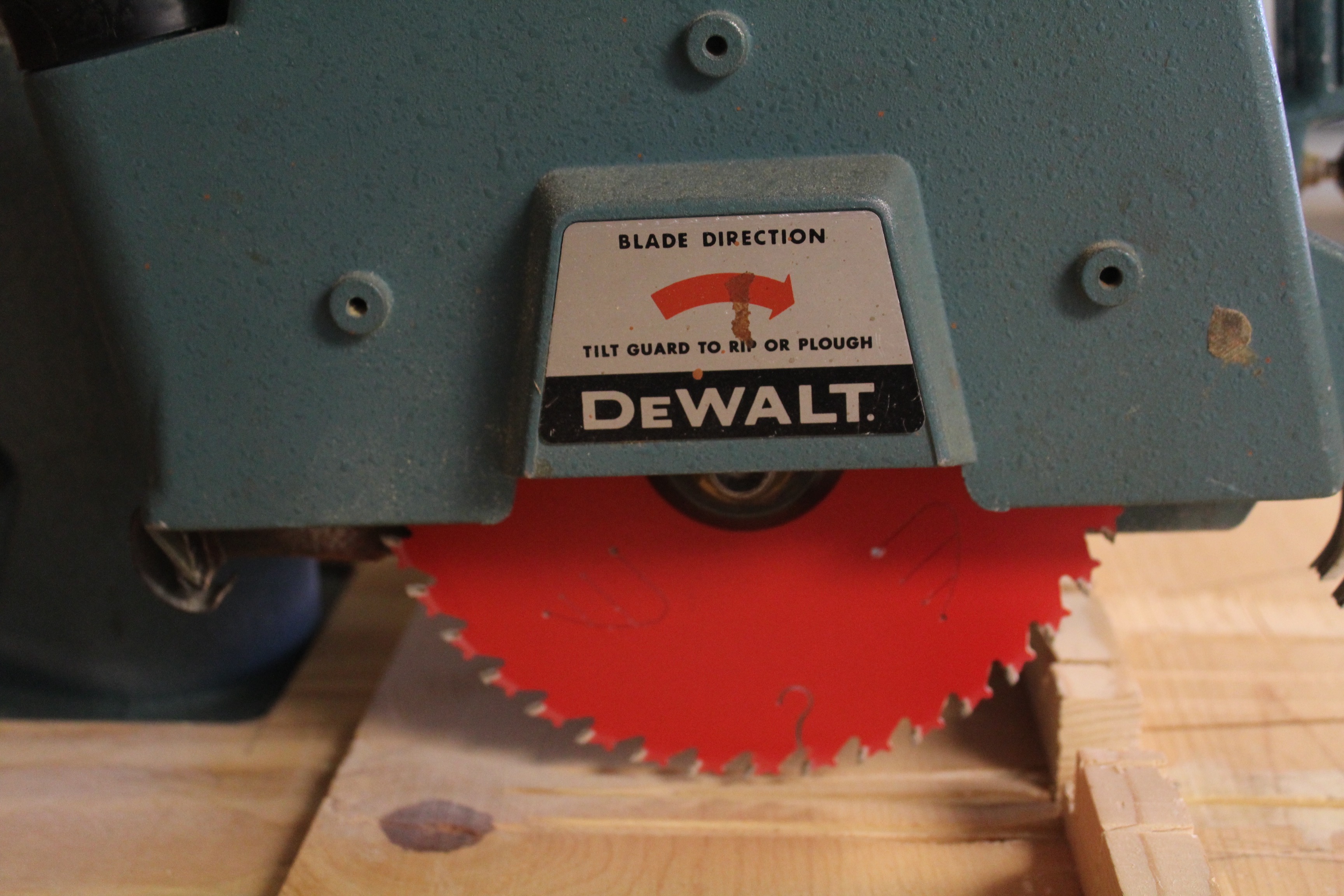 DeWalt Power Shop Radial Arm Saw on Stand and Wall of Blades