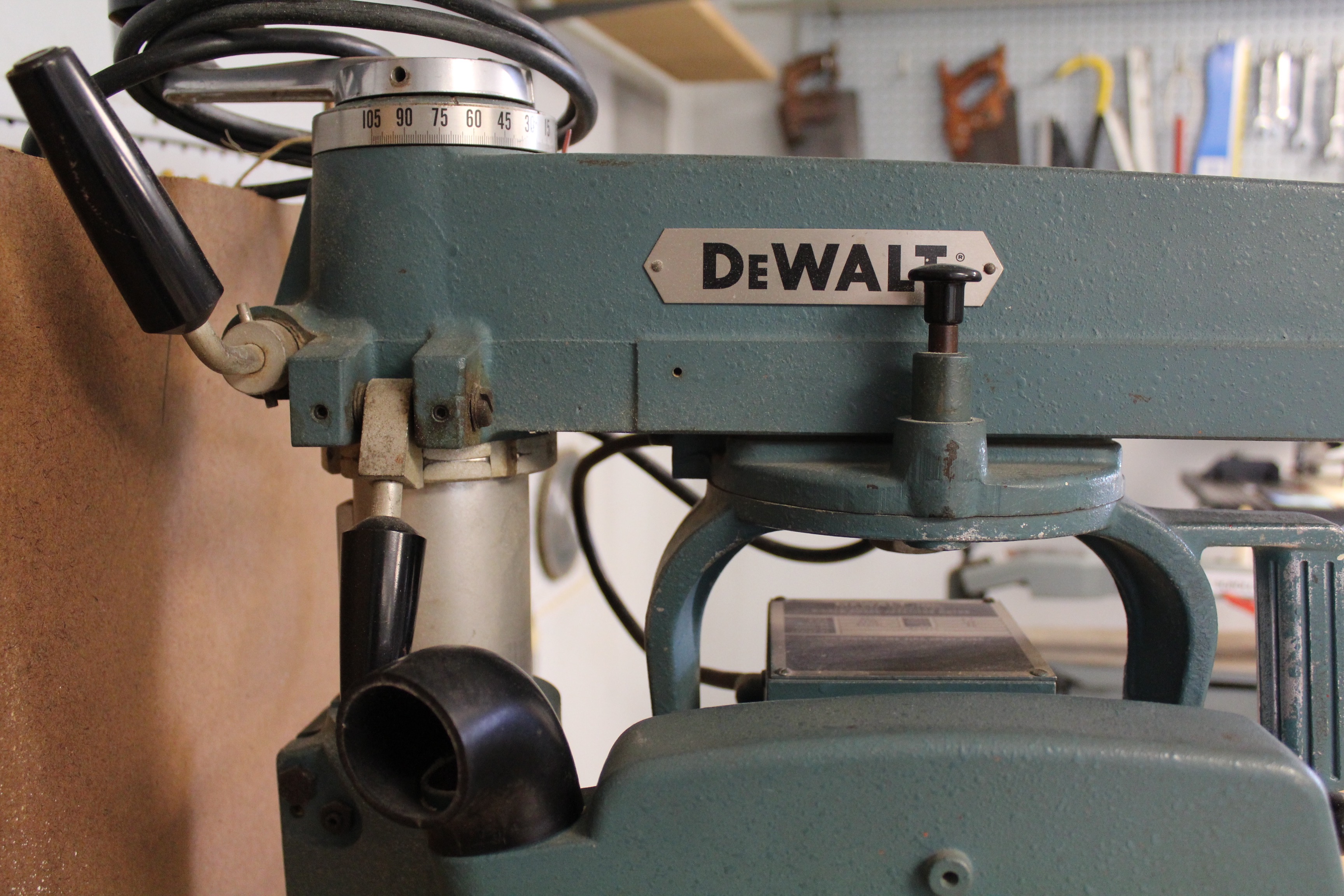 DeWalt Power Shop Radial Arm Saw on Stand and Wall of Blades