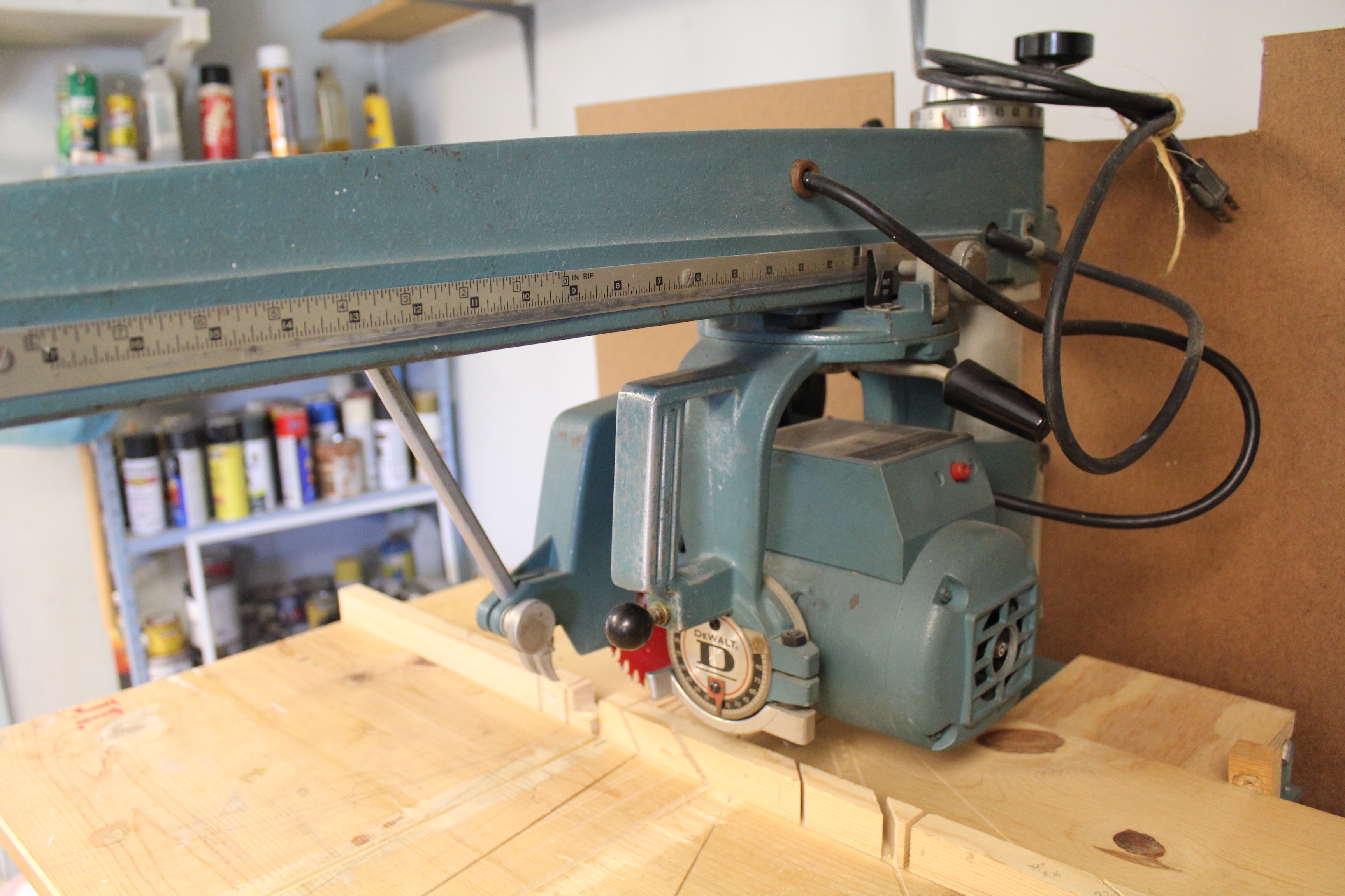 DeWalt Power Shop Radial Arm Saw on Stand and Wall of Blades