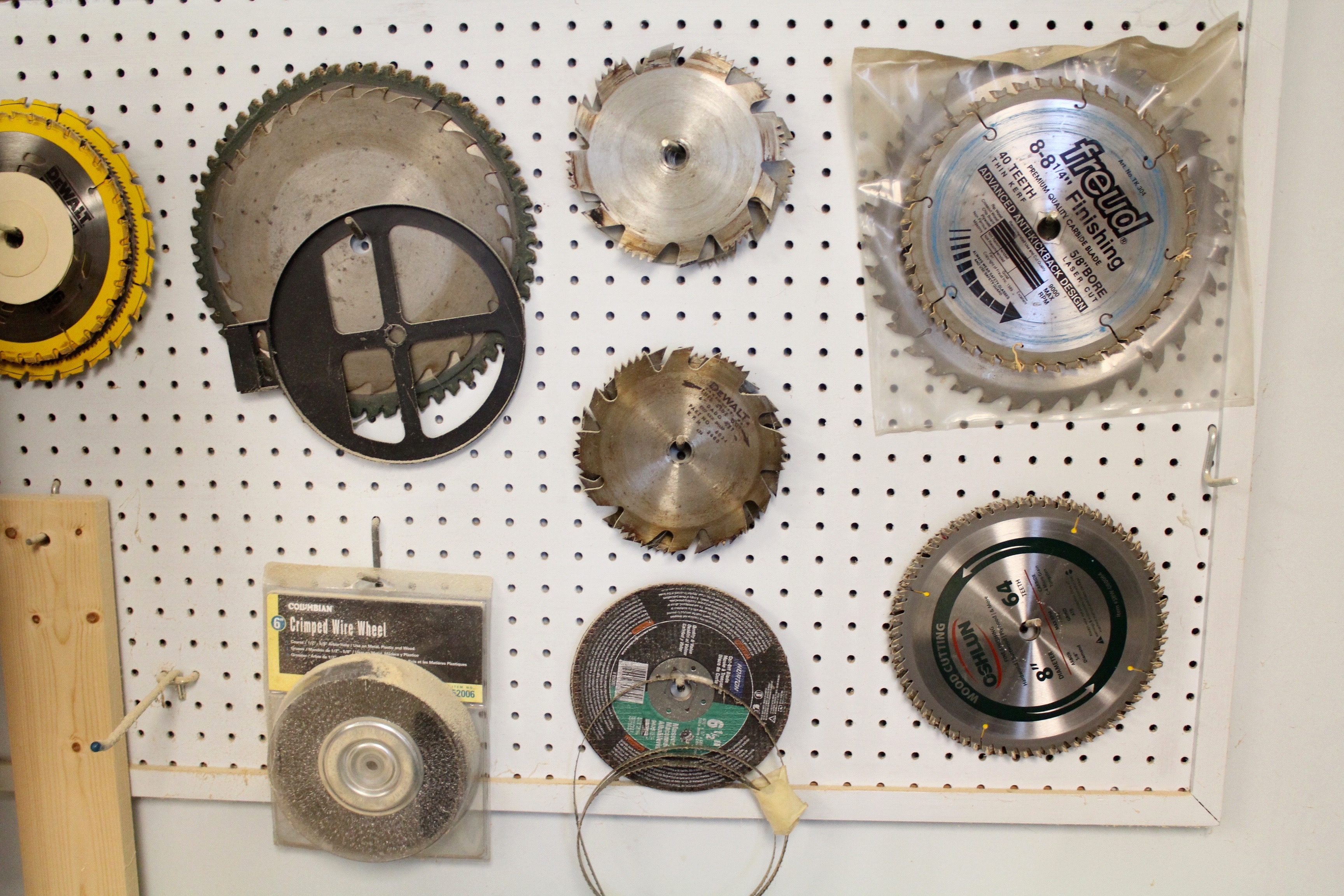 DeWalt Power Shop Radial Arm Saw on Stand and Wall of Blades