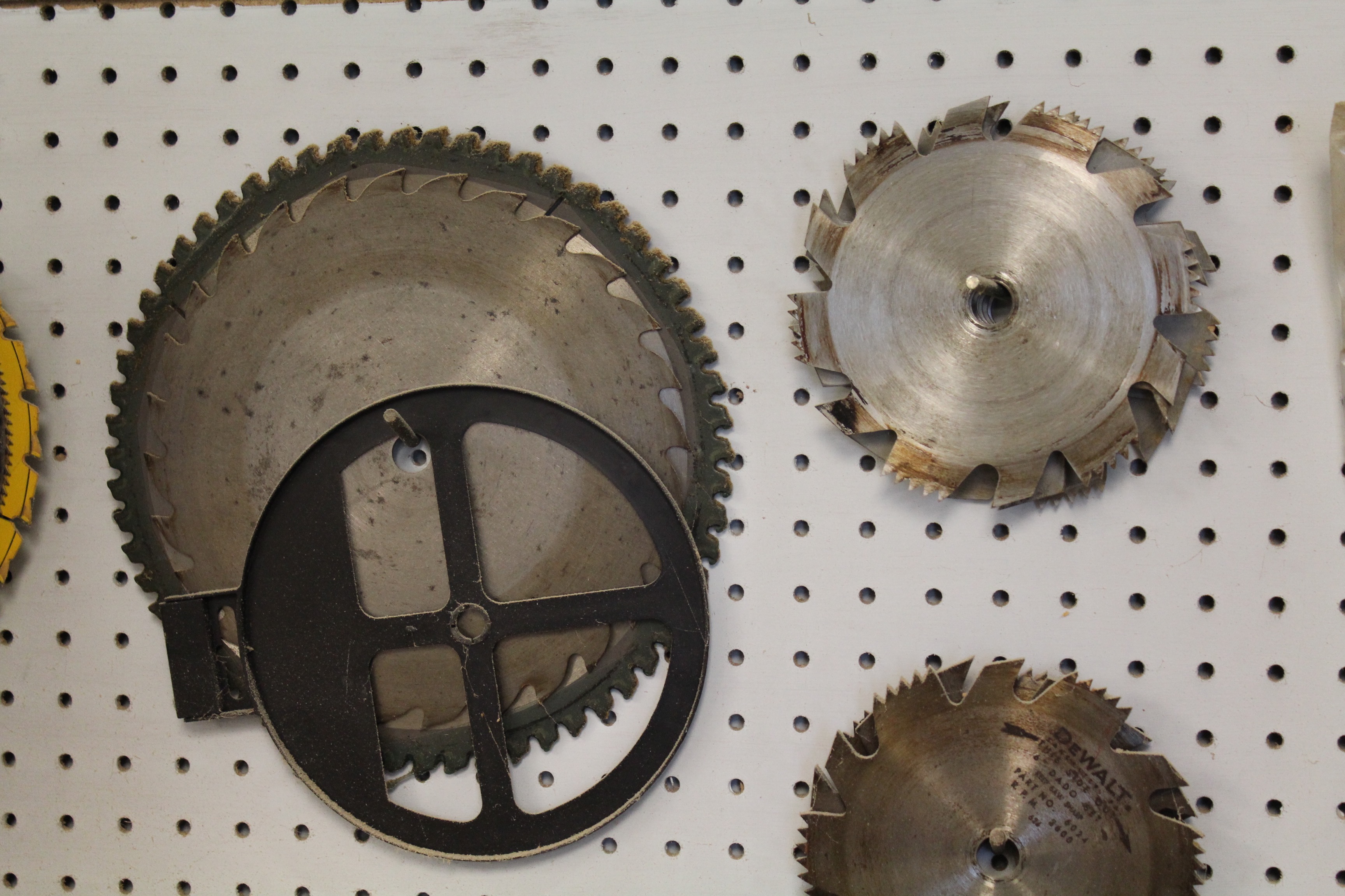 DeWalt Power Shop Radial Arm Saw on Stand and Wall of Blades