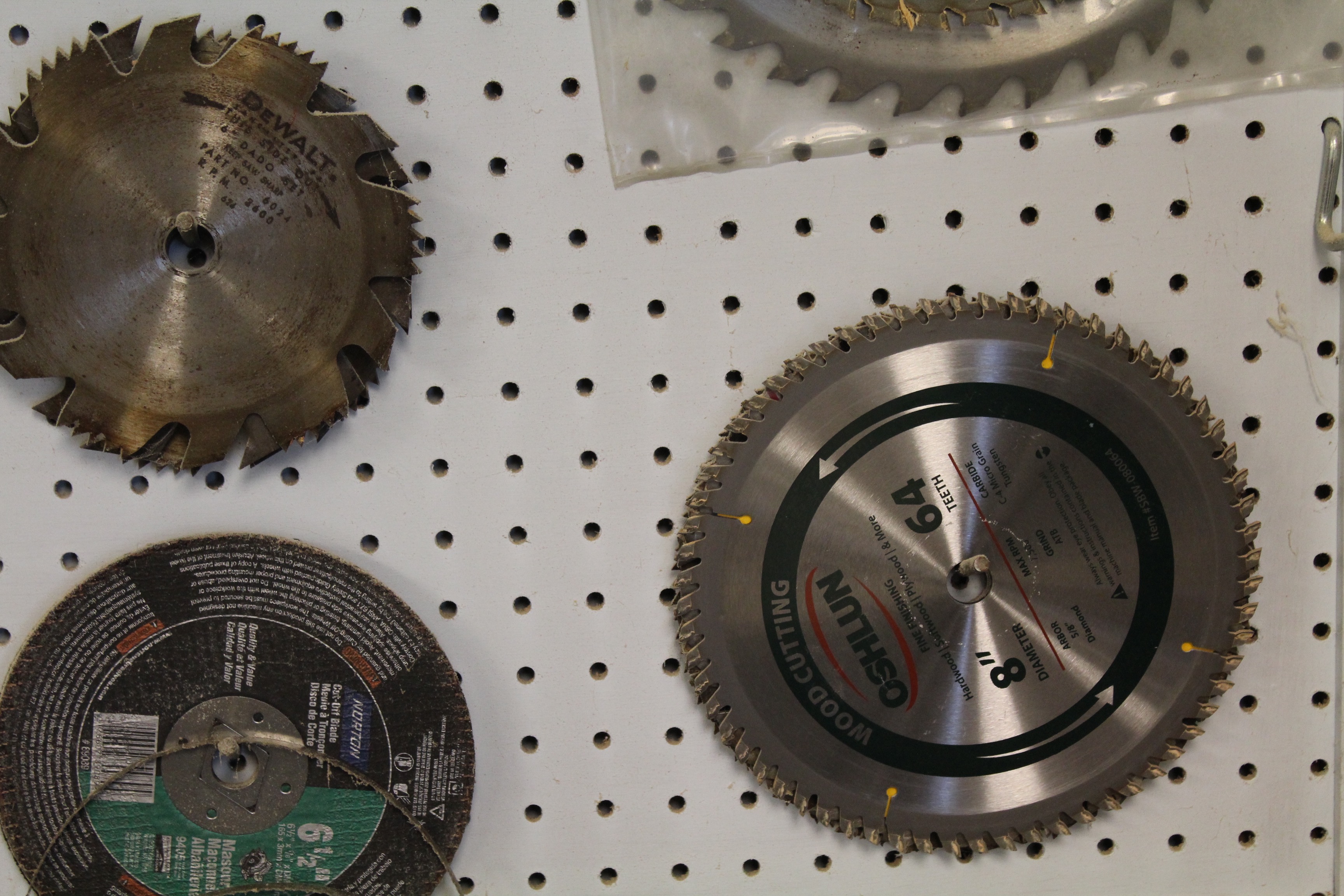 DeWalt Power Shop Radial Arm Saw on Stand and Wall of Blades