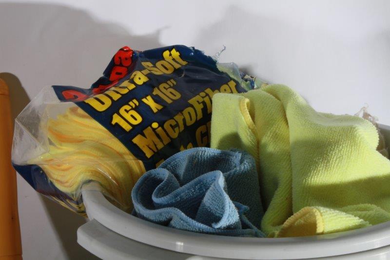 Assortment of Cleaning Supplies and Plastic Buckets