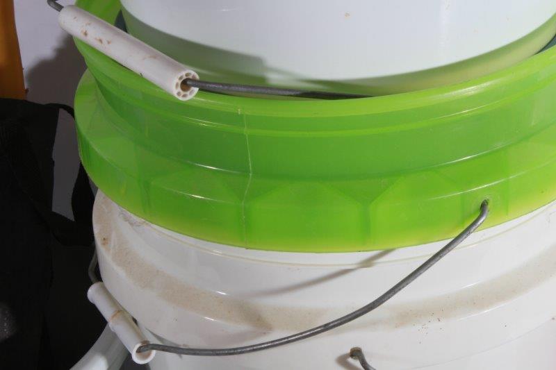 Assortment of Cleaning Supplies and Plastic Buckets