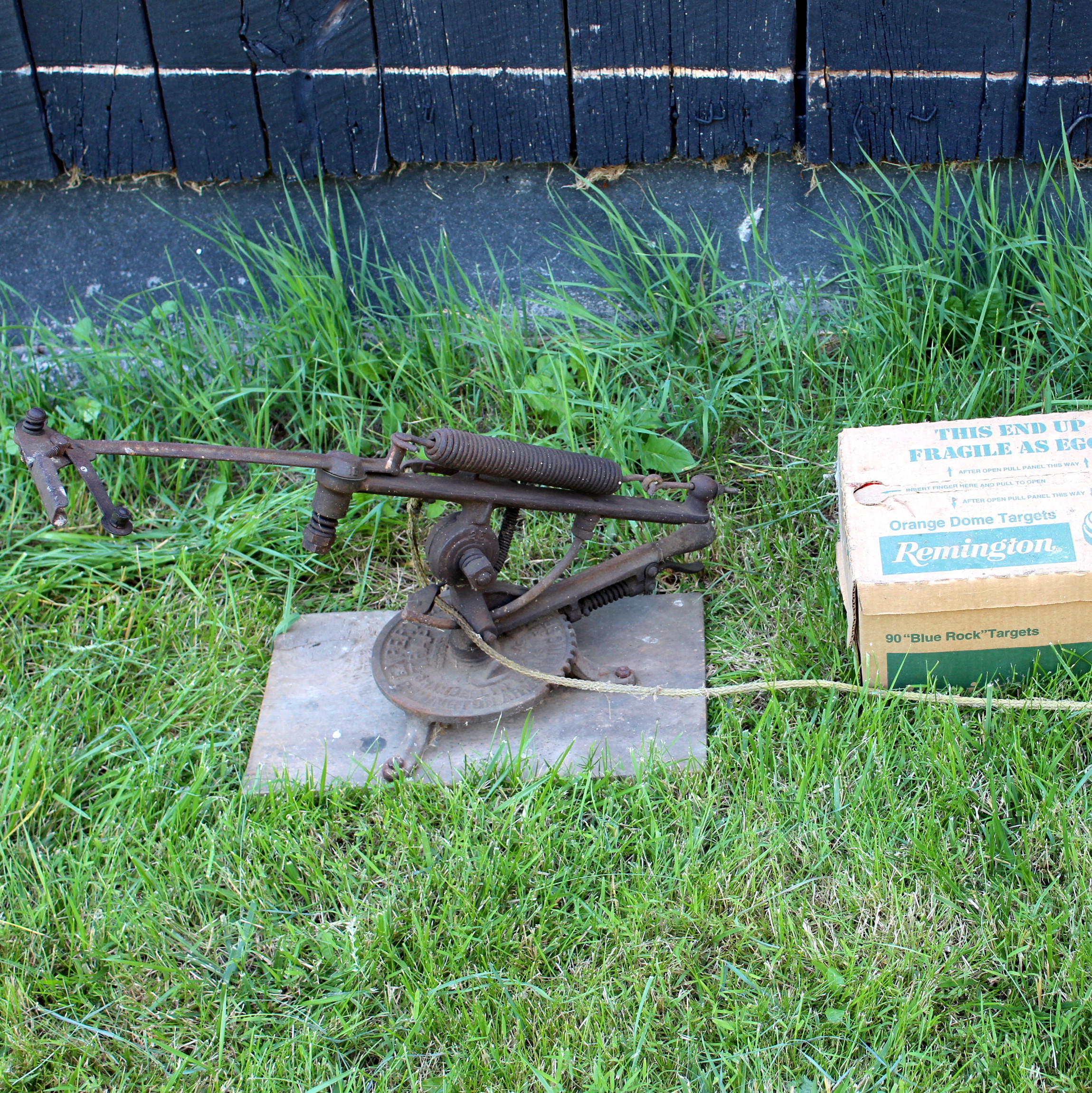 Vintage Manual Pull Trap Thrower and Box of Clays