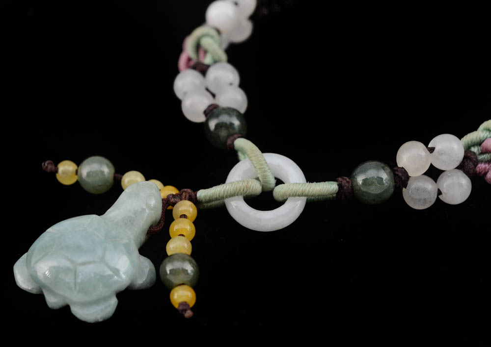 Four Jadeite Carving and Beaded Handmade Bracelets and a Tourmalinated Quartz Necklace with Plastic Beads