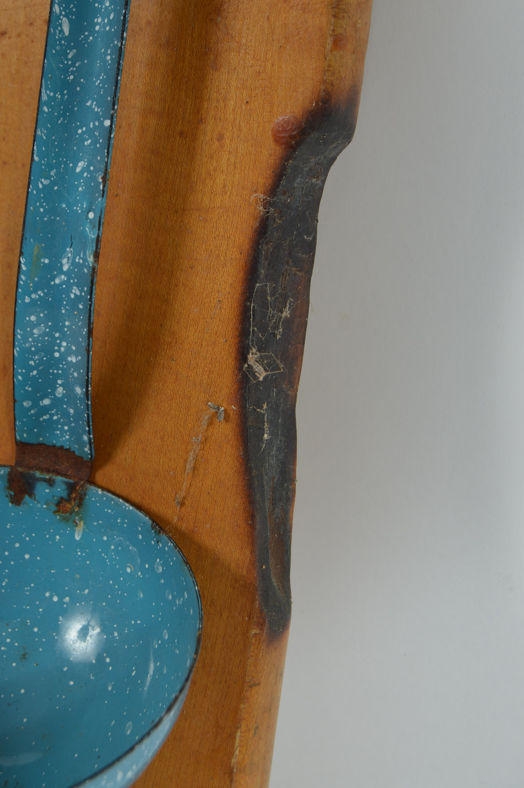 Collection of Speckled Enamel Ware Utensils Mounted on a Cutting Board
