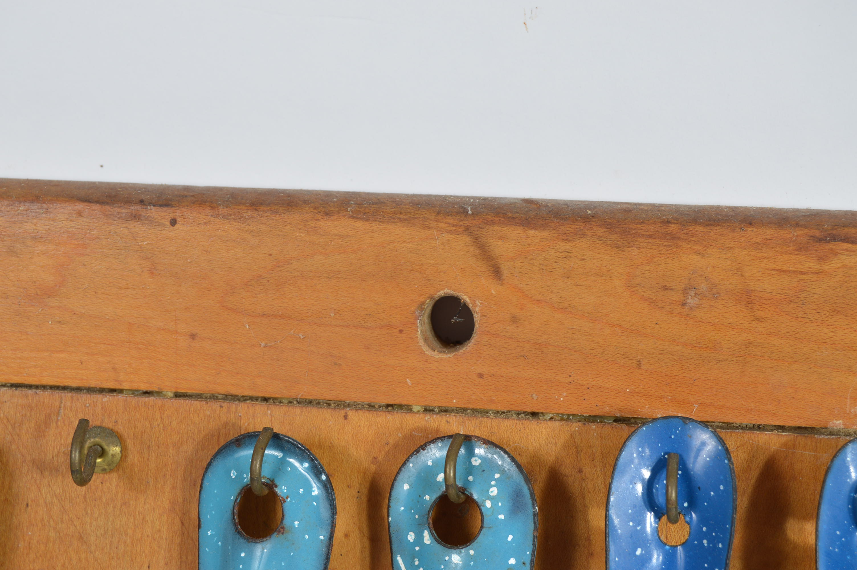 Collection of Speckled Enamel Ware Utensils Mounted on a Cutting Board