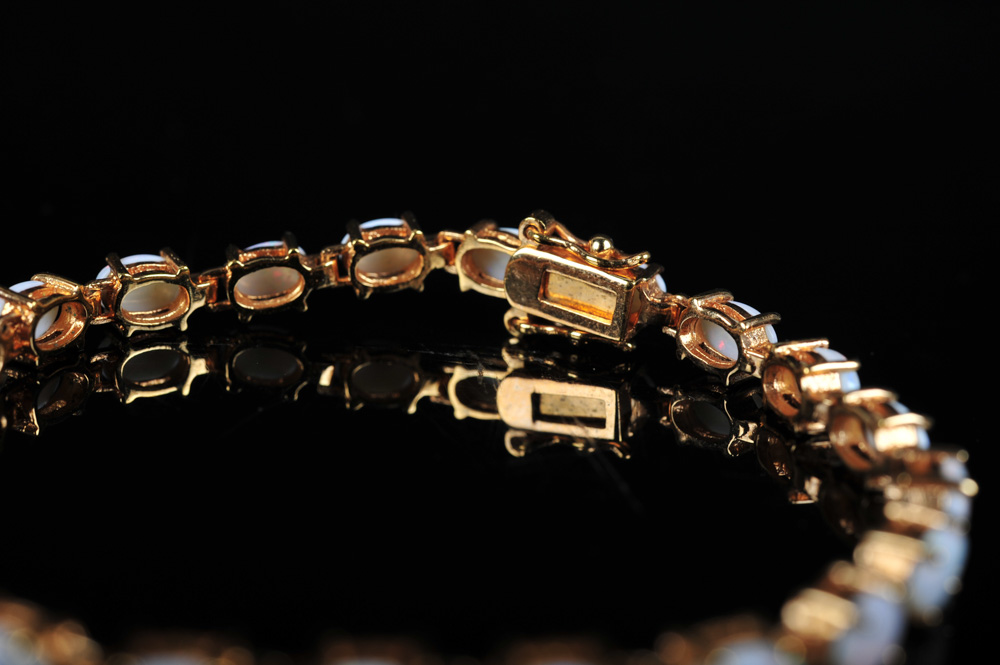 Pair of Gold Tone Bracelets Featuring Imitation Diamonds and Gemstones