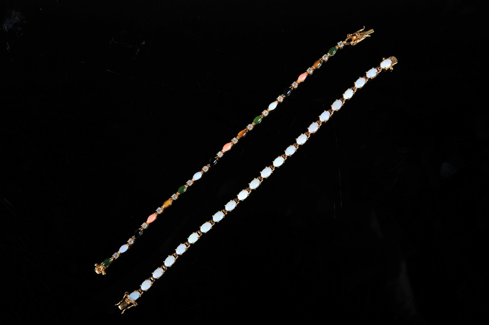 Pair of Gold Tone Bracelets Featuring Imitation Diamonds and Gemstones