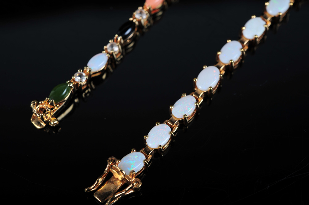 Pair of Gold Tone Bracelets Featuring Imitation Diamonds and Gemstones