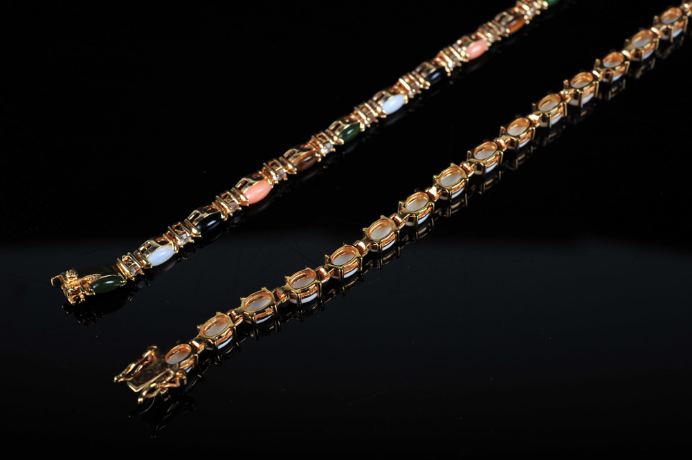 Pair of Gold Tone Bracelets Featuring Imitation Diamonds and Gemstones