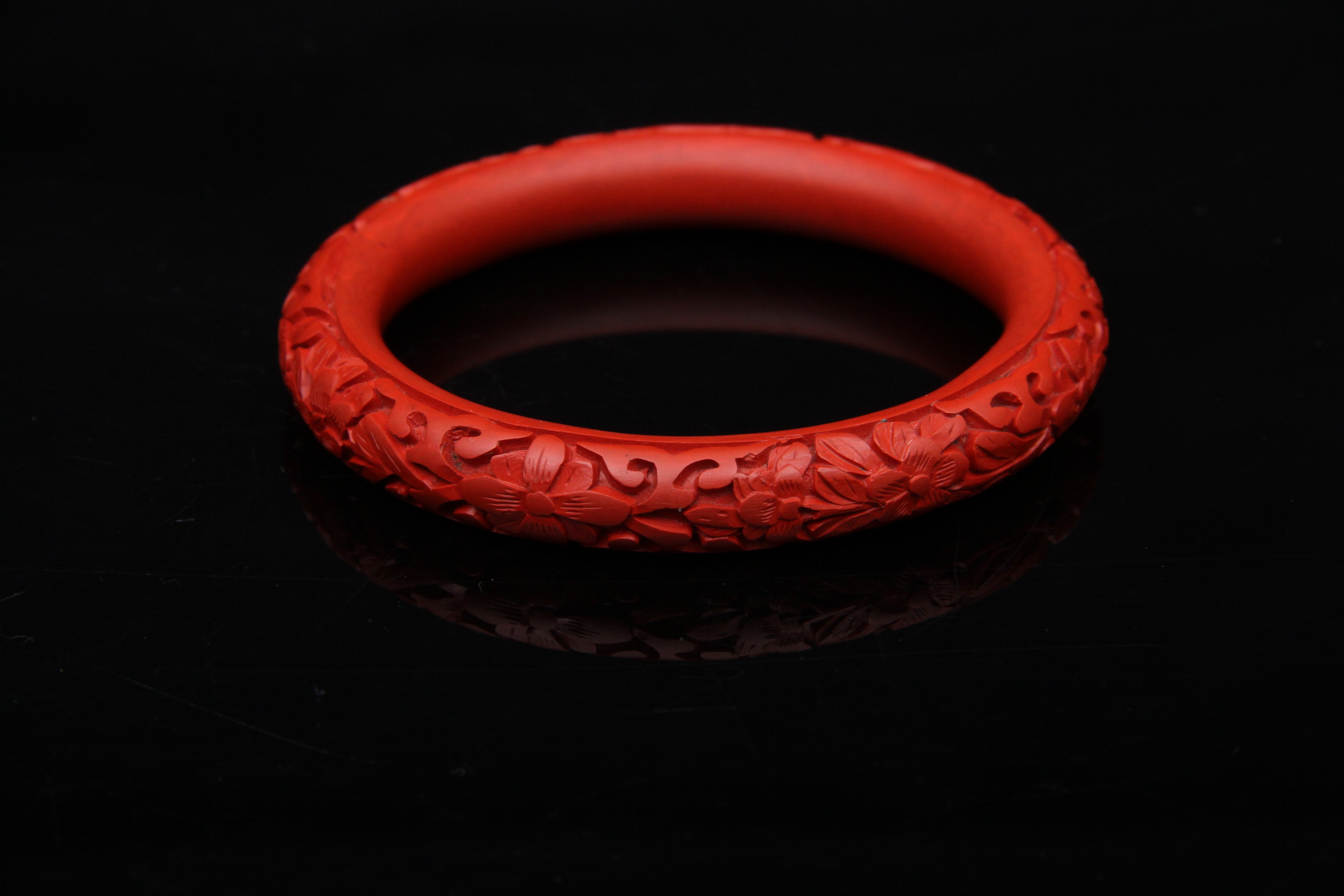 Pair of Carved Cinnabar Bangles and Earrings