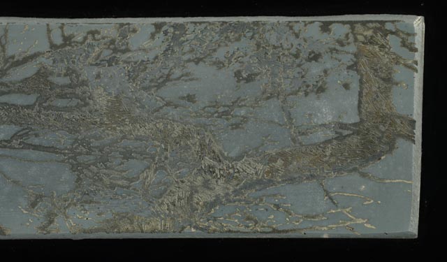 Collaged Steel Intaglio Plates and Faux Wood Veneer on Black Acrylic Substrate