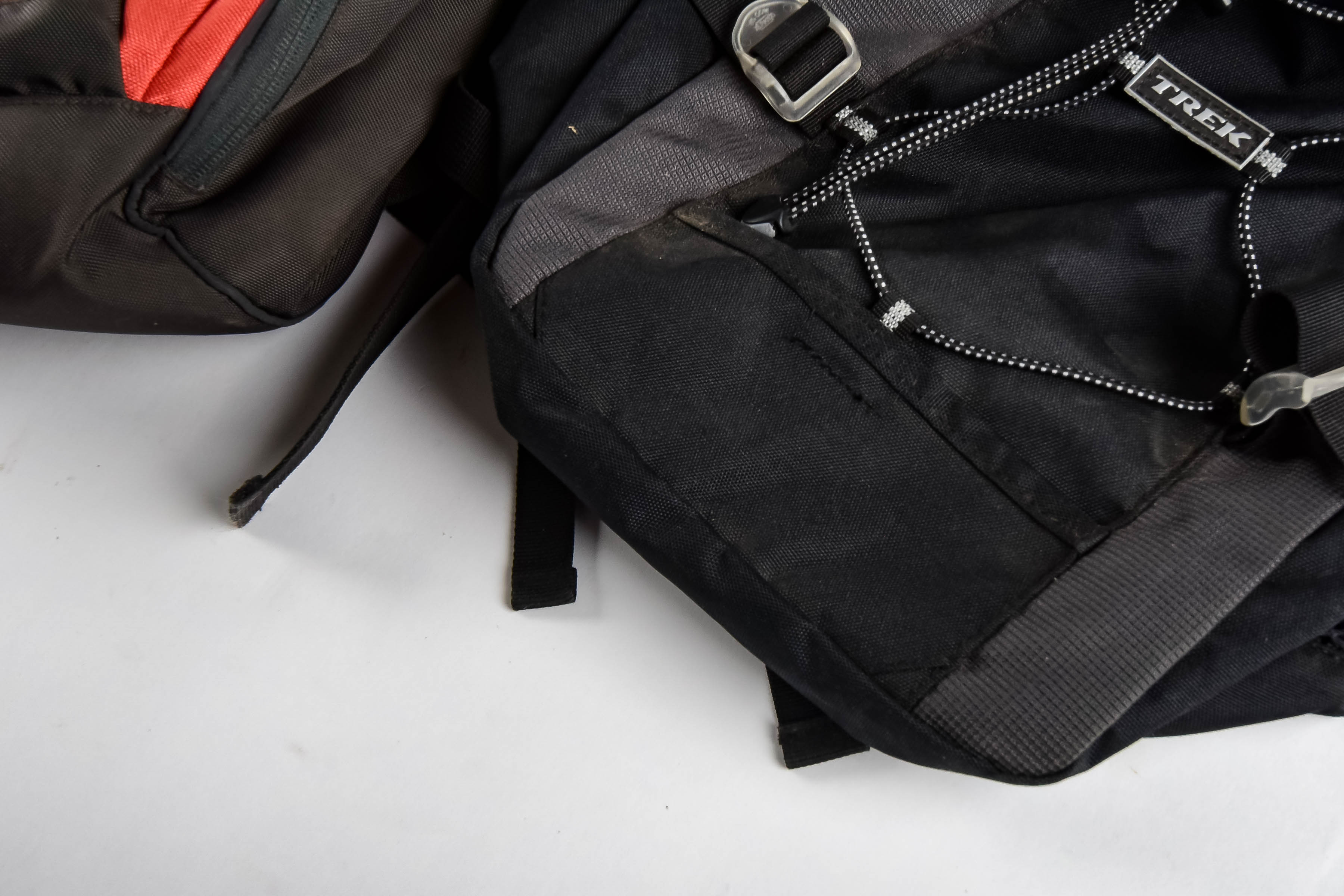 Four Black and Red Backpacks Including Trek