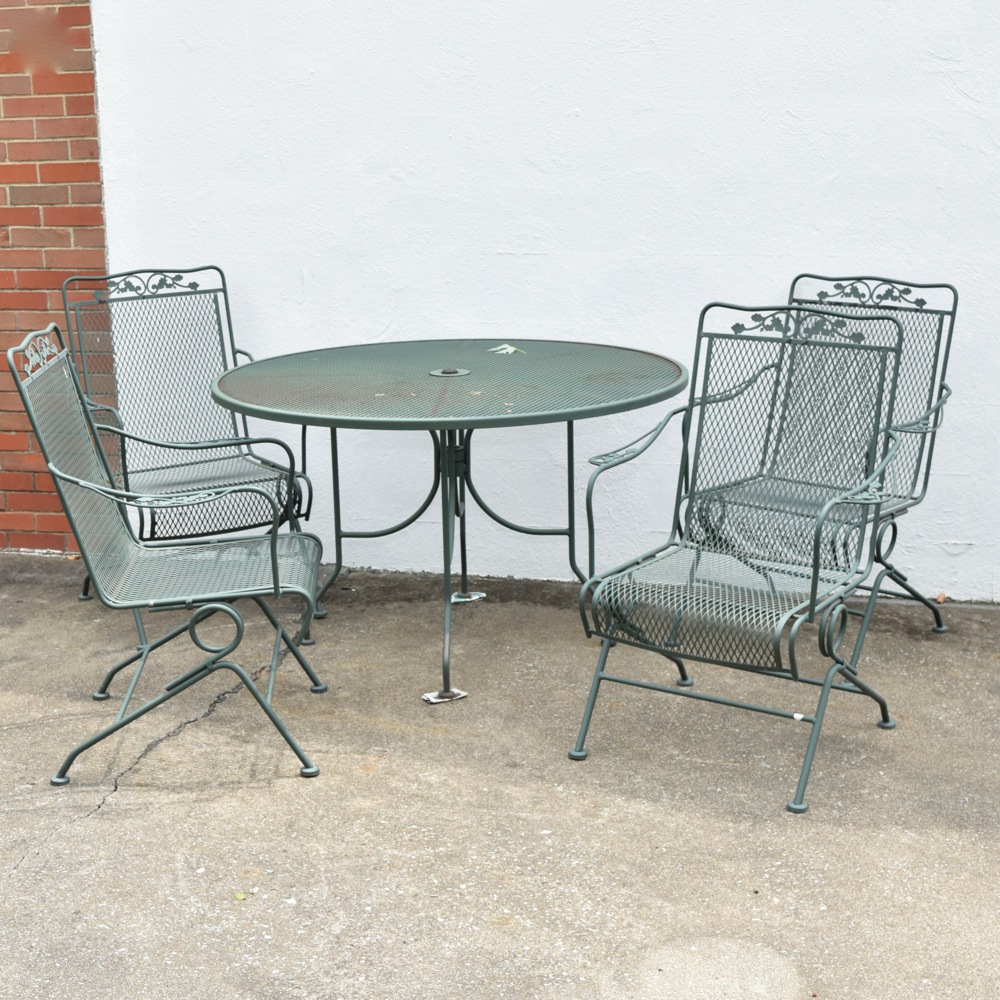 Wrought Iron Patio Table and Four Wrought Iron Rocking Chairs