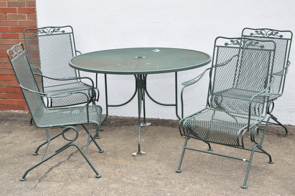 Wrought Iron Patio Table and Four Wrought Iron Rocking Chairs