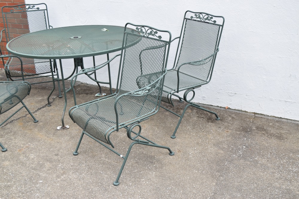 Wrought Iron Patio Table and Four Wrought Iron Rocking Chairs