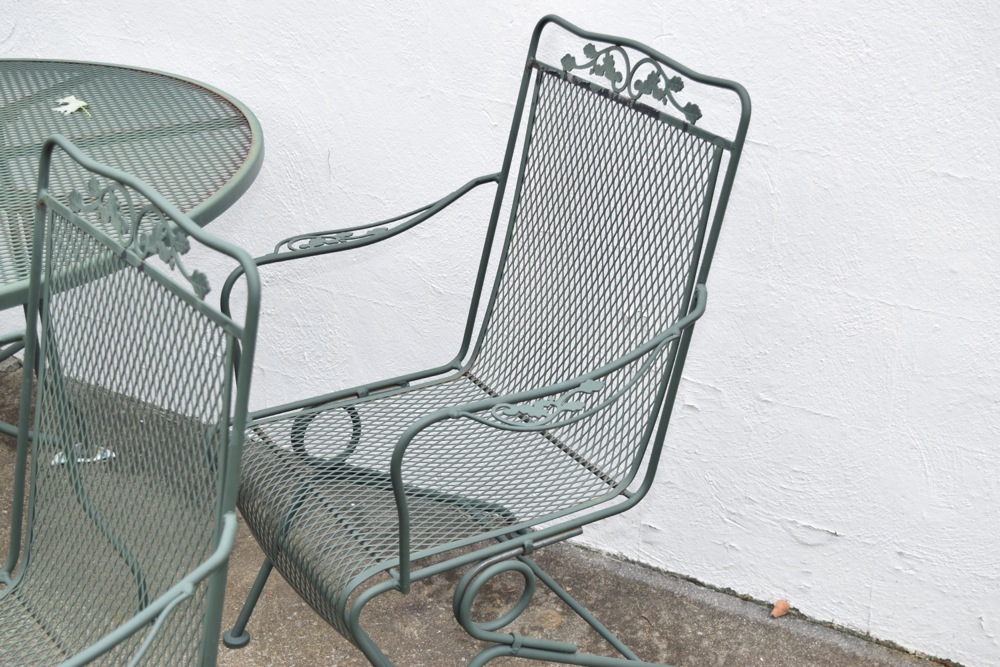 Wrought Iron Patio Table and Four Wrought Iron Rocking Chairs