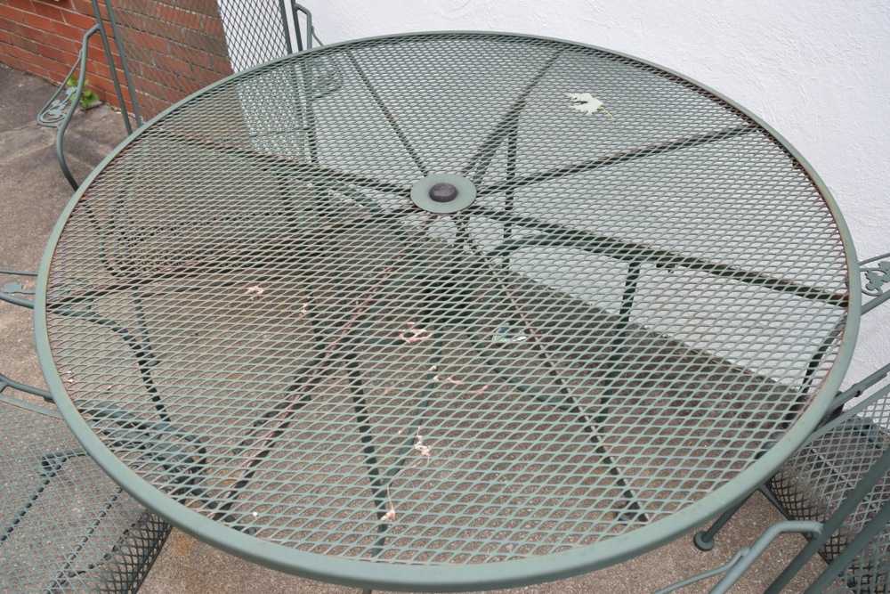 Wrought Iron Patio Table and Four Wrought Iron Rocking Chairs