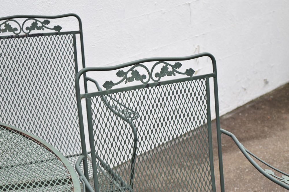 Wrought Iron Patio Table and Four Wrought Iron Rocking Chairs