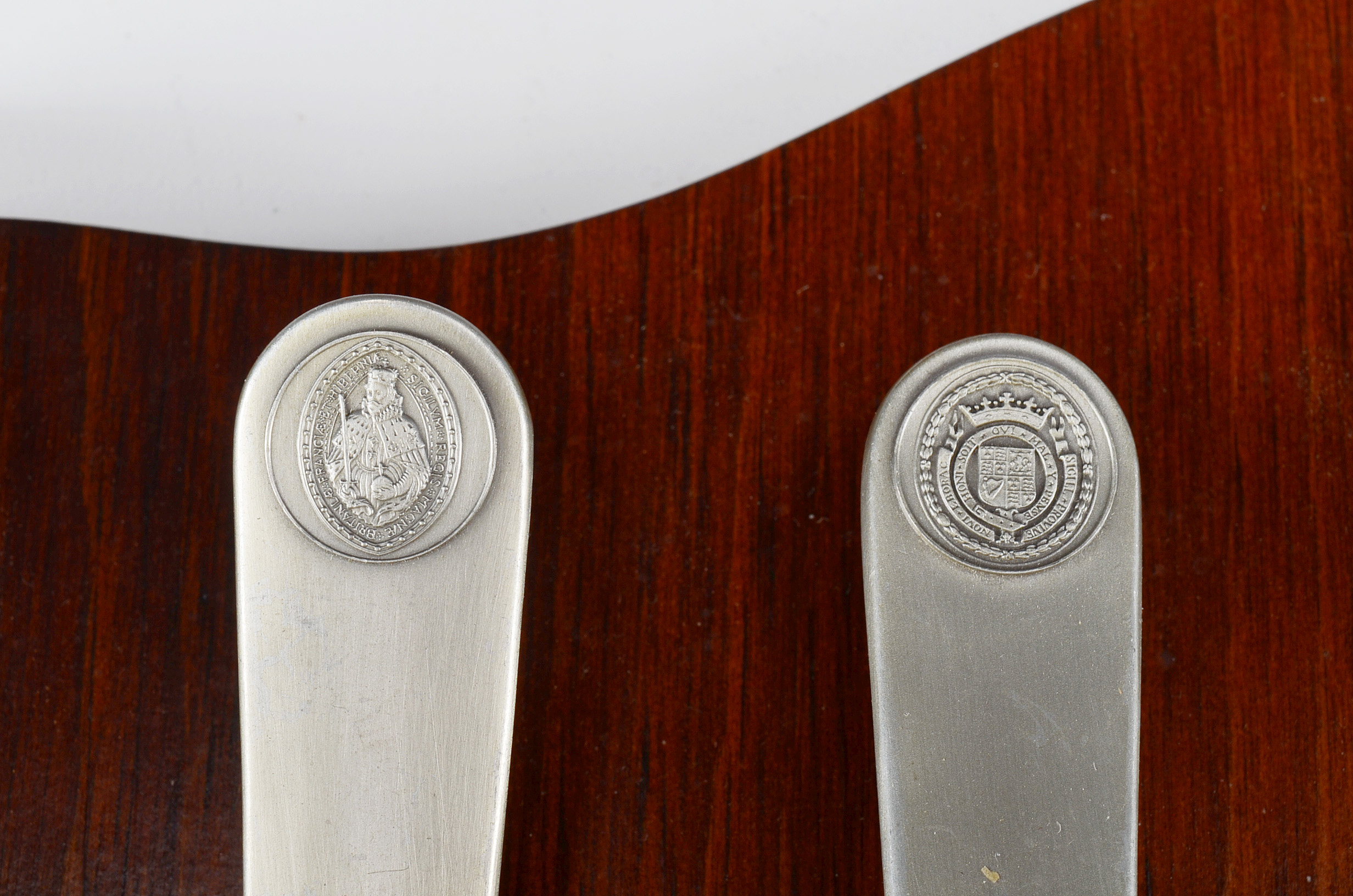 Collection of Thirteen Original State Spoons Displayed in Wooden Shelf