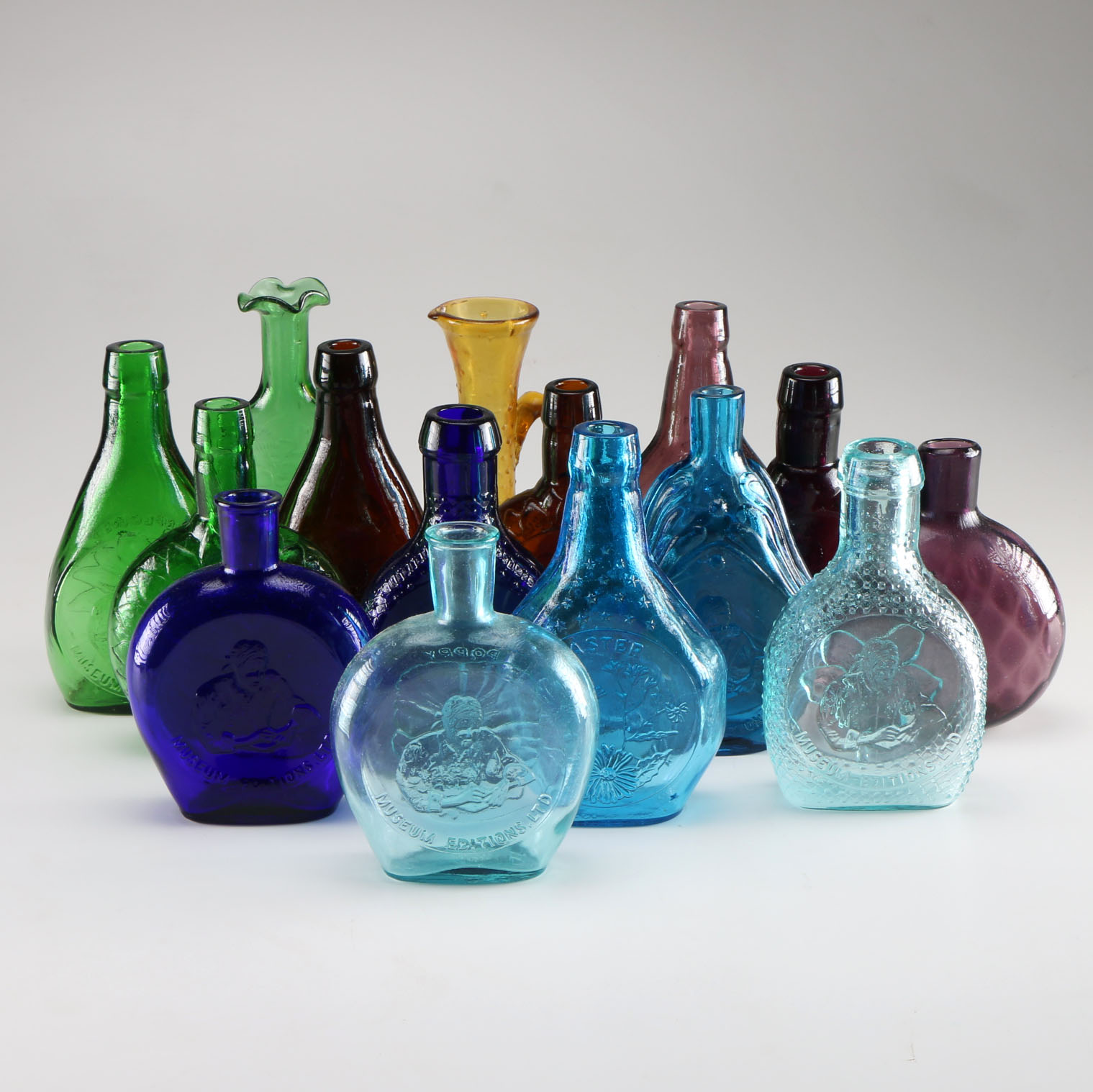 Assortment of Clevenger Brothers Colored Glass Bottles