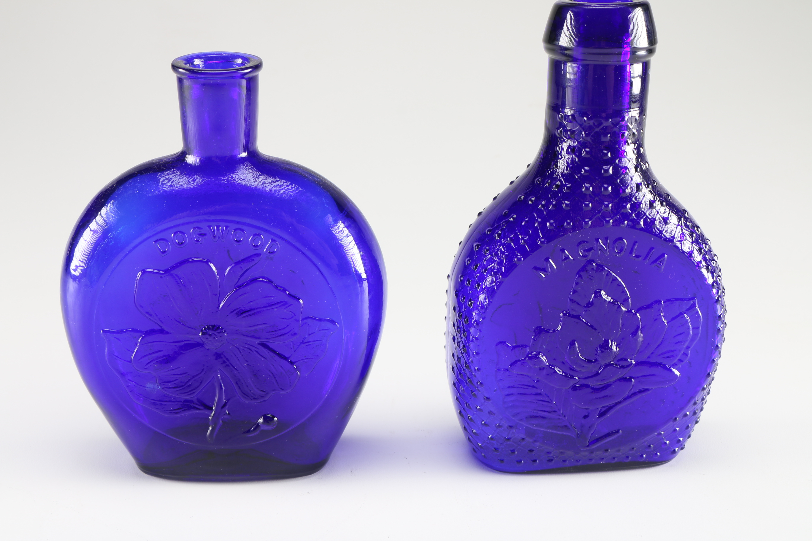 Assortment of Clevenger Brothers Colored Glass Bottles