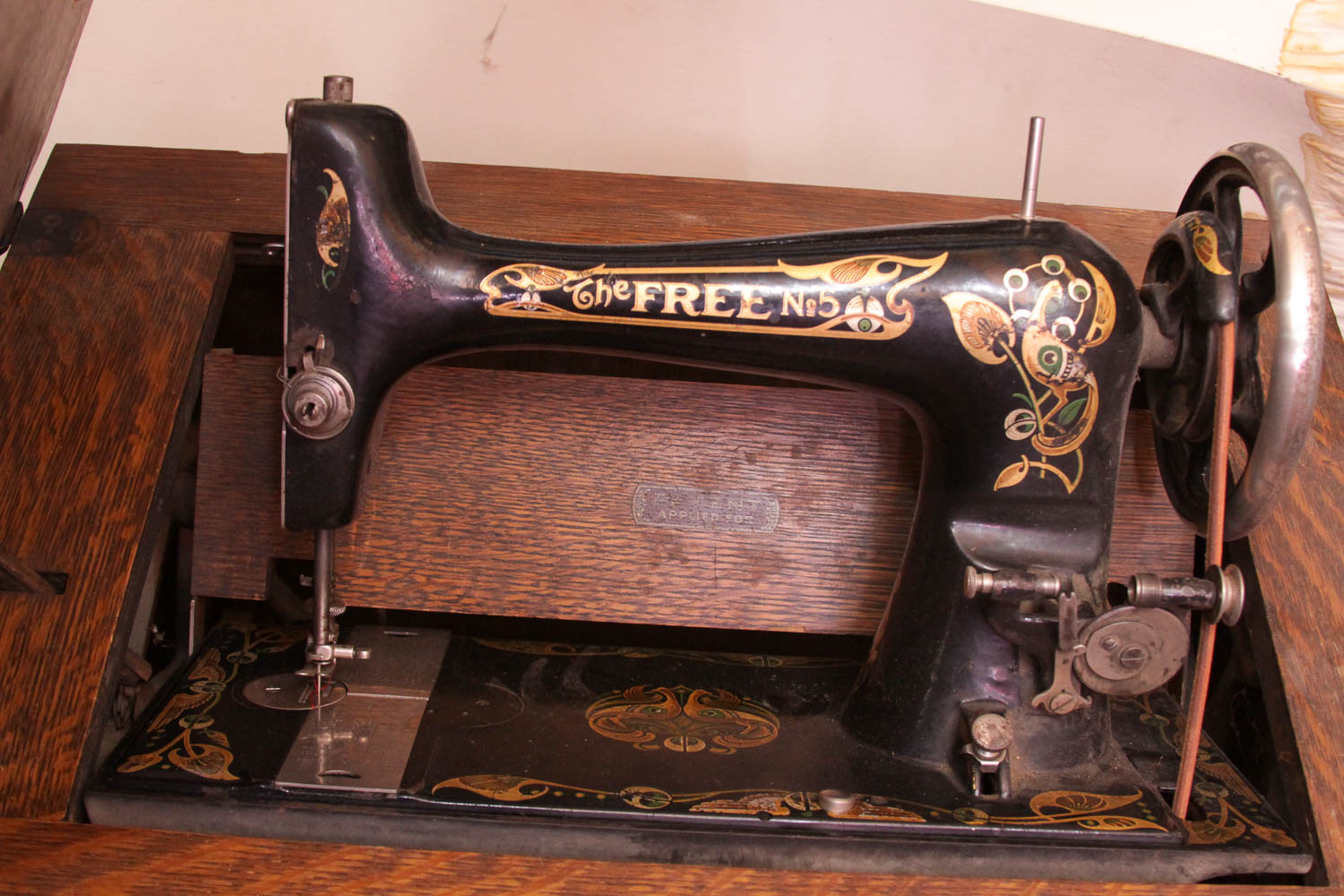 Antique Sewing Machine in Oak Cabinet by Free Co.