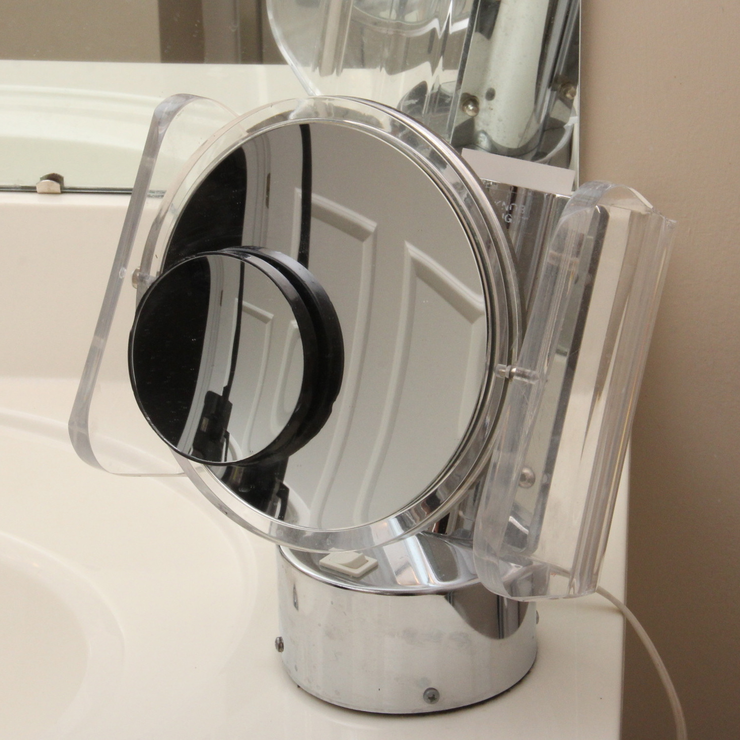 Magnifying Mirror, Metal Wall Sconce, and Table Lamp